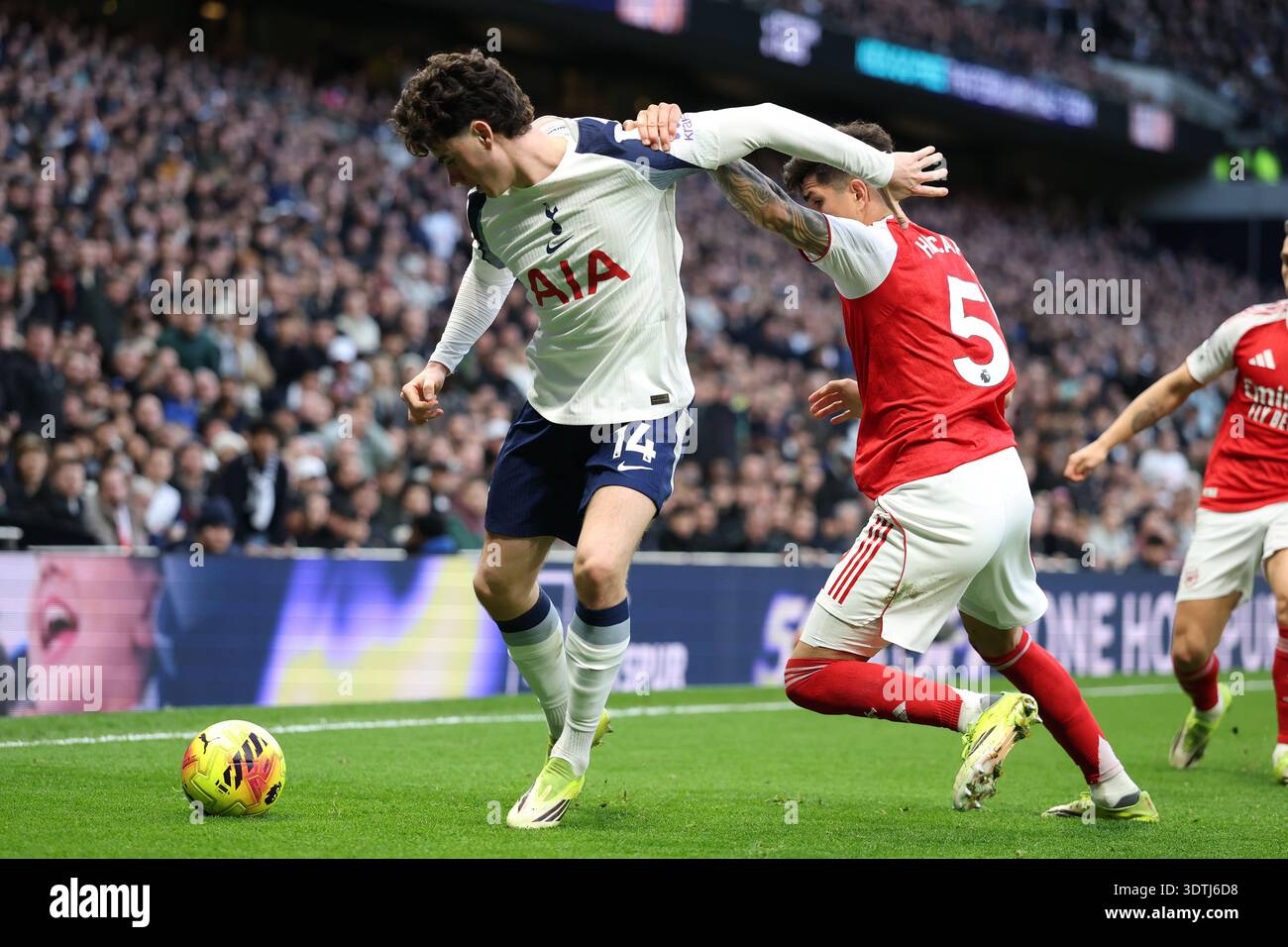 Tottenham's Archie Gray, left, and Arsenal's Piero Hincapie challenge ...