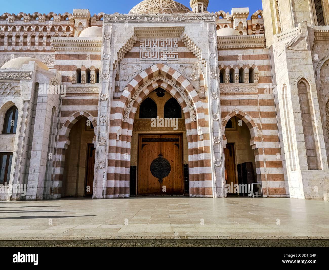 Egypt, Sharm El Sheikh - January 18, 2020: Entrance to the Al Mustafa Mosque in Sharm El Sheikh, front view. Facade of a striped Muslim temple - Smartphone Captured Stock Image