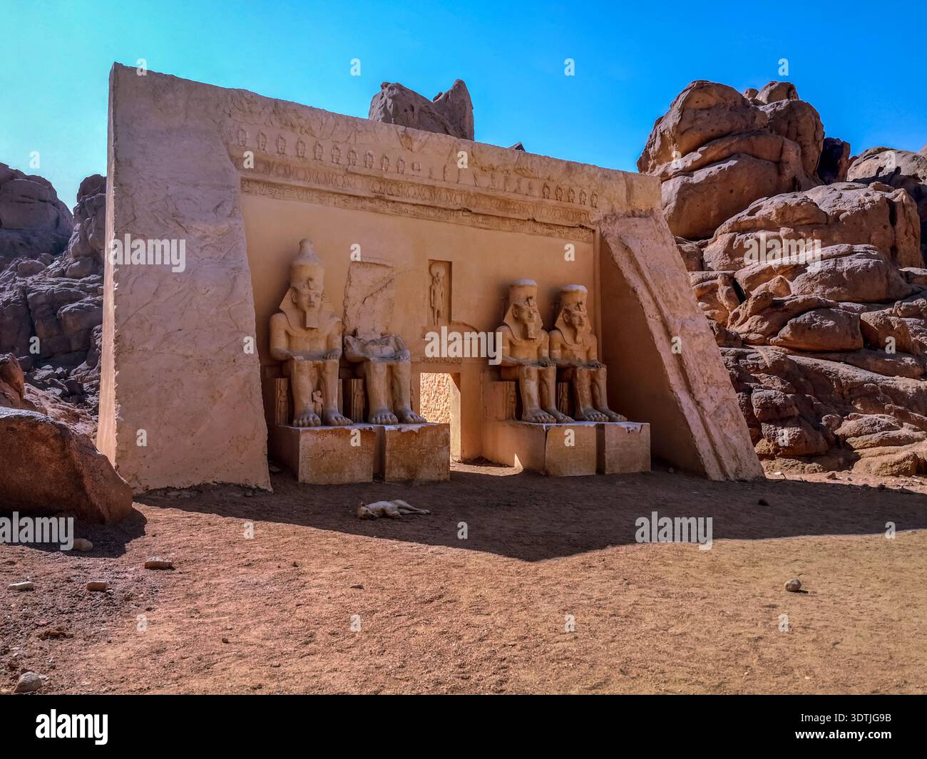 A modern copy of the entrance of the ancient Temple of Ramses II in the South Sinai Desert near Sharm El Sheikh (Egypt). Four sitting  human sculpture - Smartphone Captured Stock Image