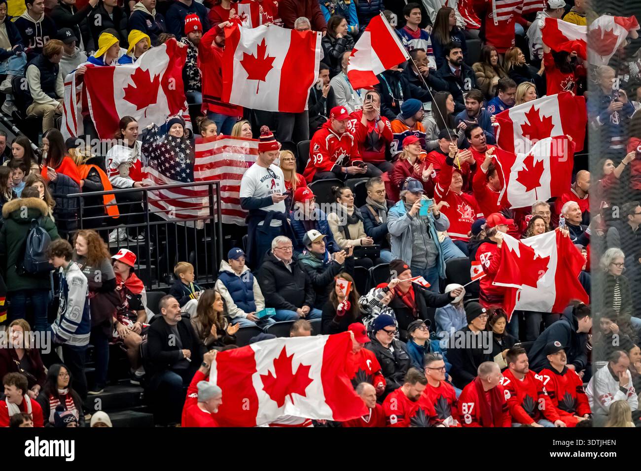 Fans cheer on their team as Team Canada and Team USA play their Gold ...