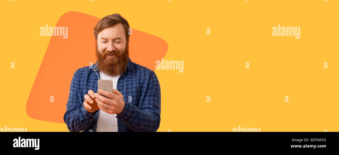 Man Using Smartphone While Standing Against a Bright Yellow Background During Daytime Stock Photo