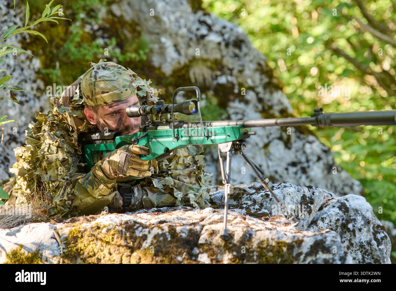 Camouflaged Sniper Lying on Rocky Ridge Aiming High-Powered Sniper ...