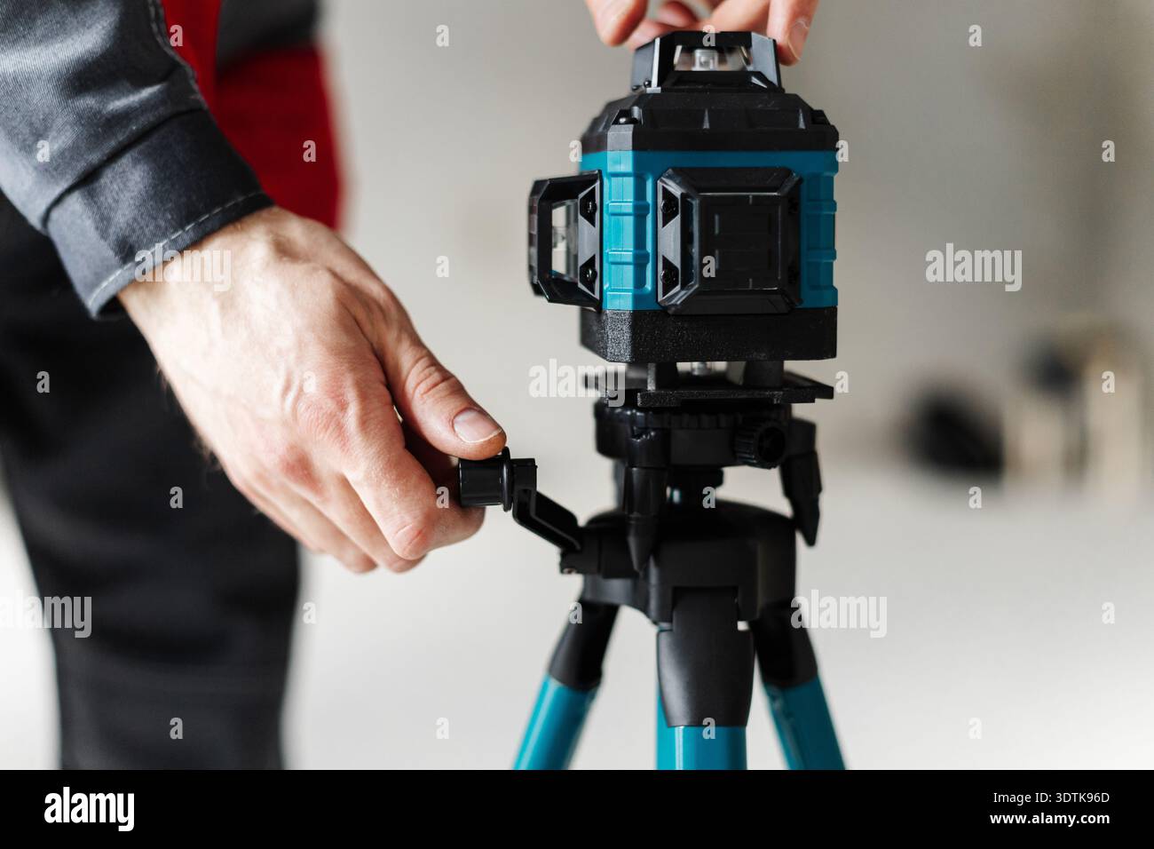 Hand adjusting laser level hi-res stock photography and images - Alamy