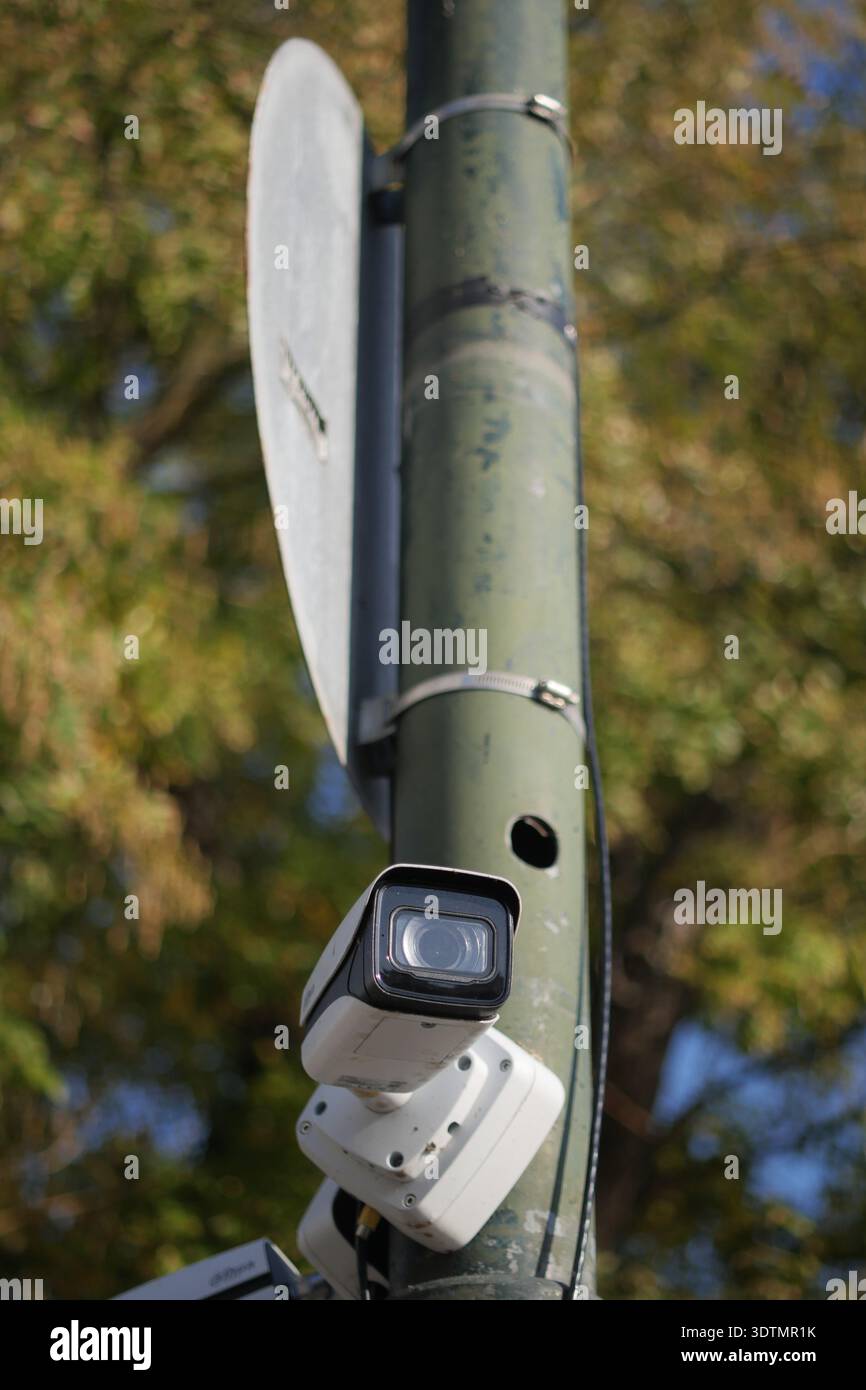 Security camera on a pole in a public area Stock Photo