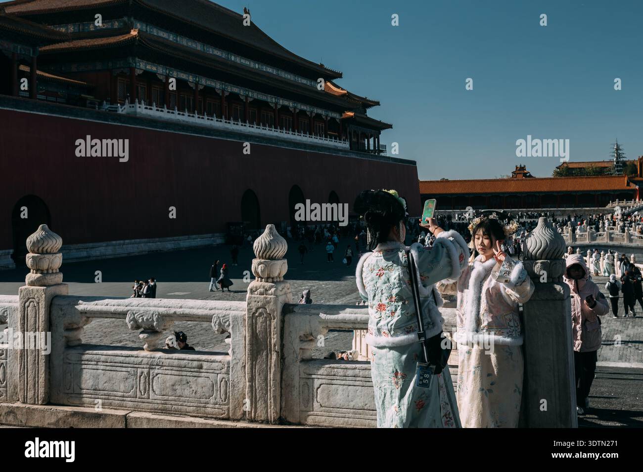 Women in traditional winter Hanfu clothing taking selfie at Forbidden ...