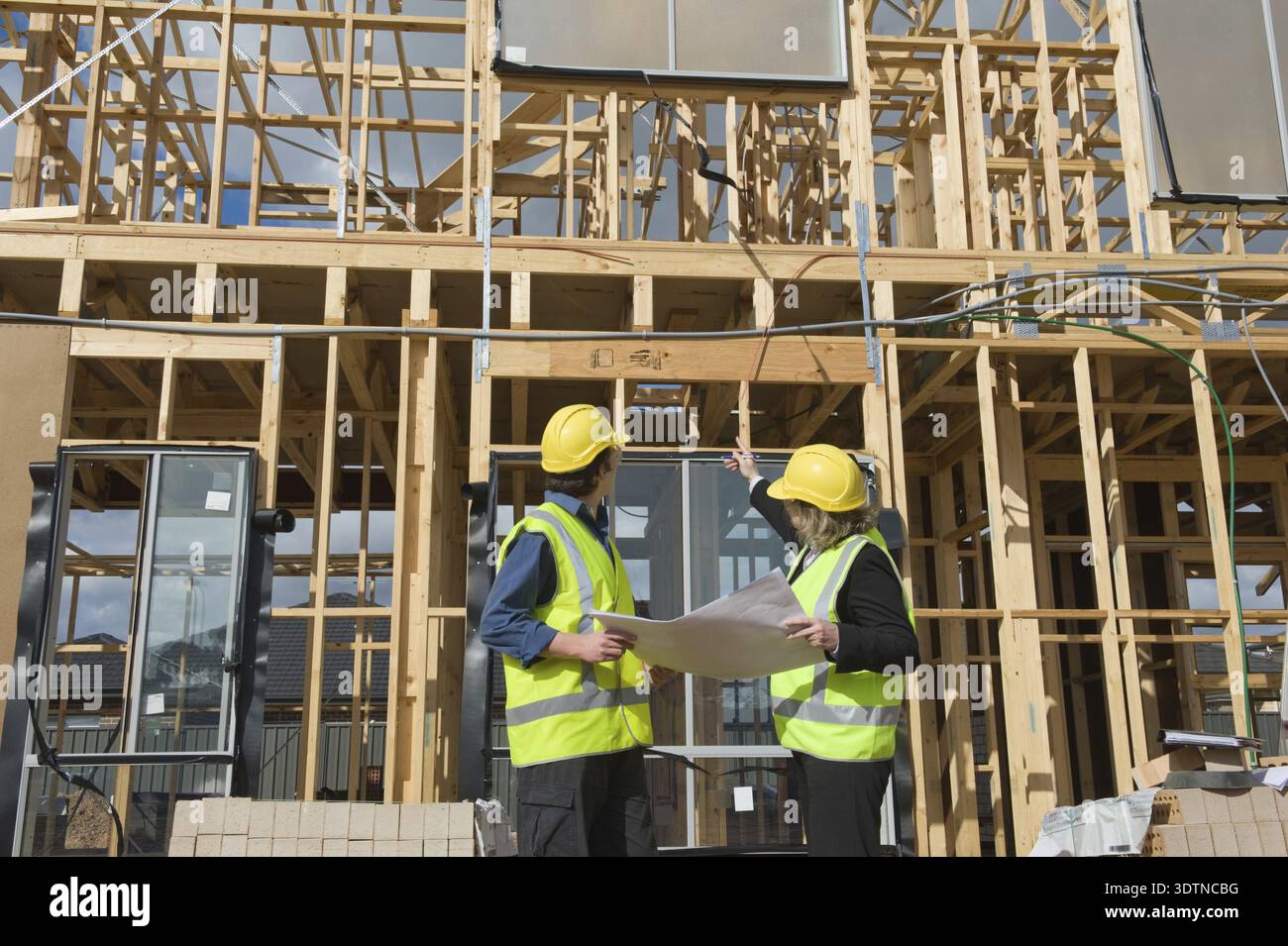 Civil engineer and worker discussing issues at the construction site Stock Photo
