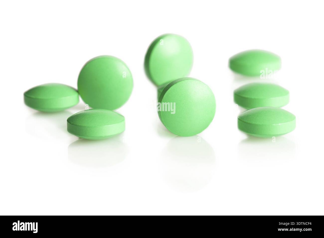 Group of green pills on white background Stock Photo