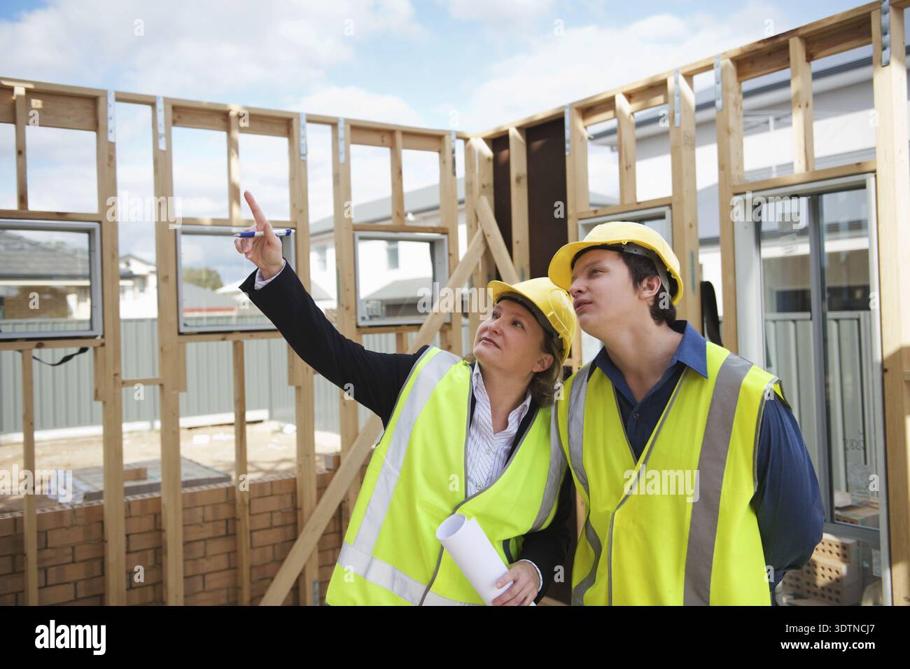 Civil engineer and worker discussing issues at the construction site Stock Photo