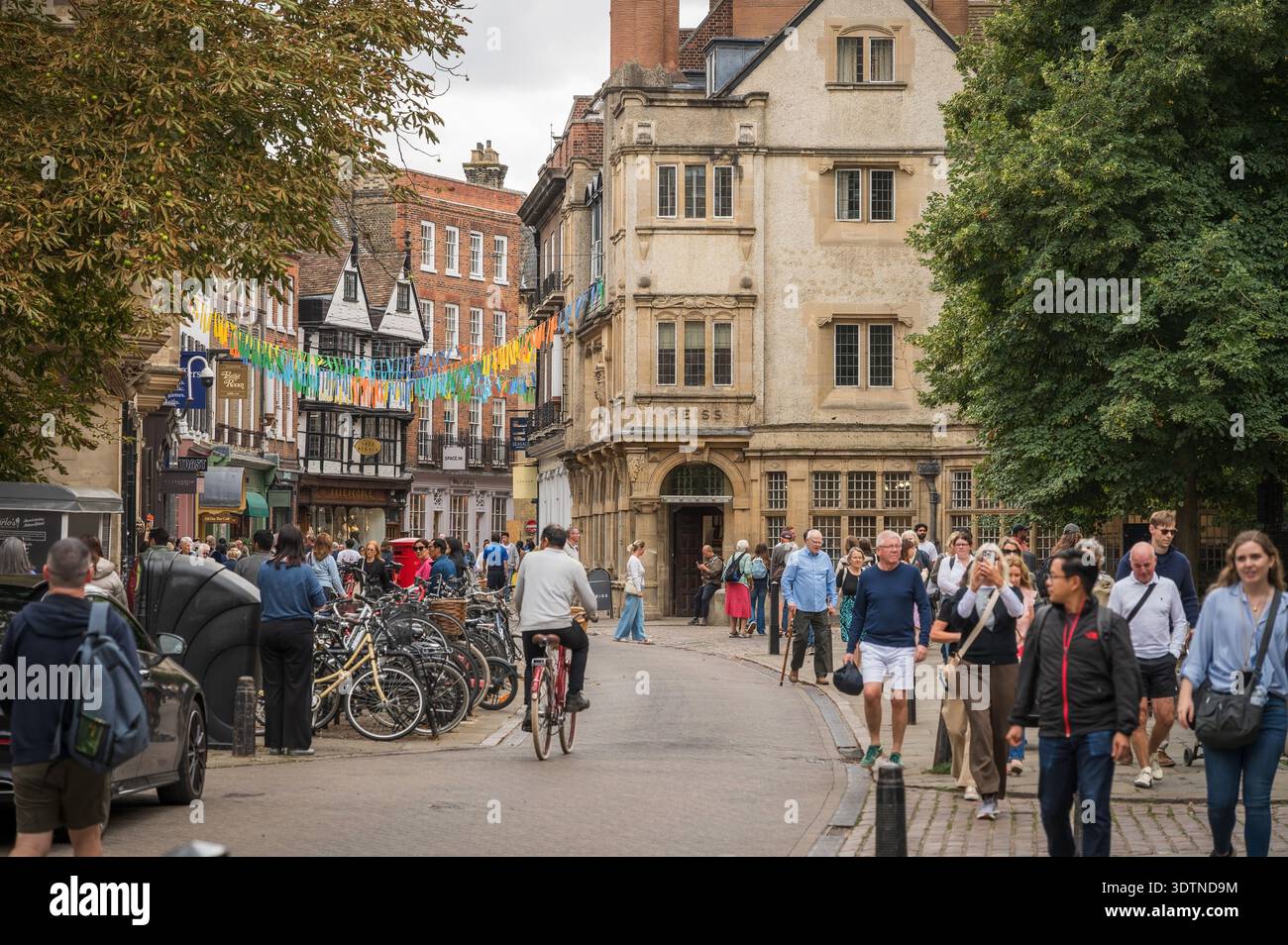 Tourists walk along Trinity Street.  Cambridge University, UK. Stock Photo