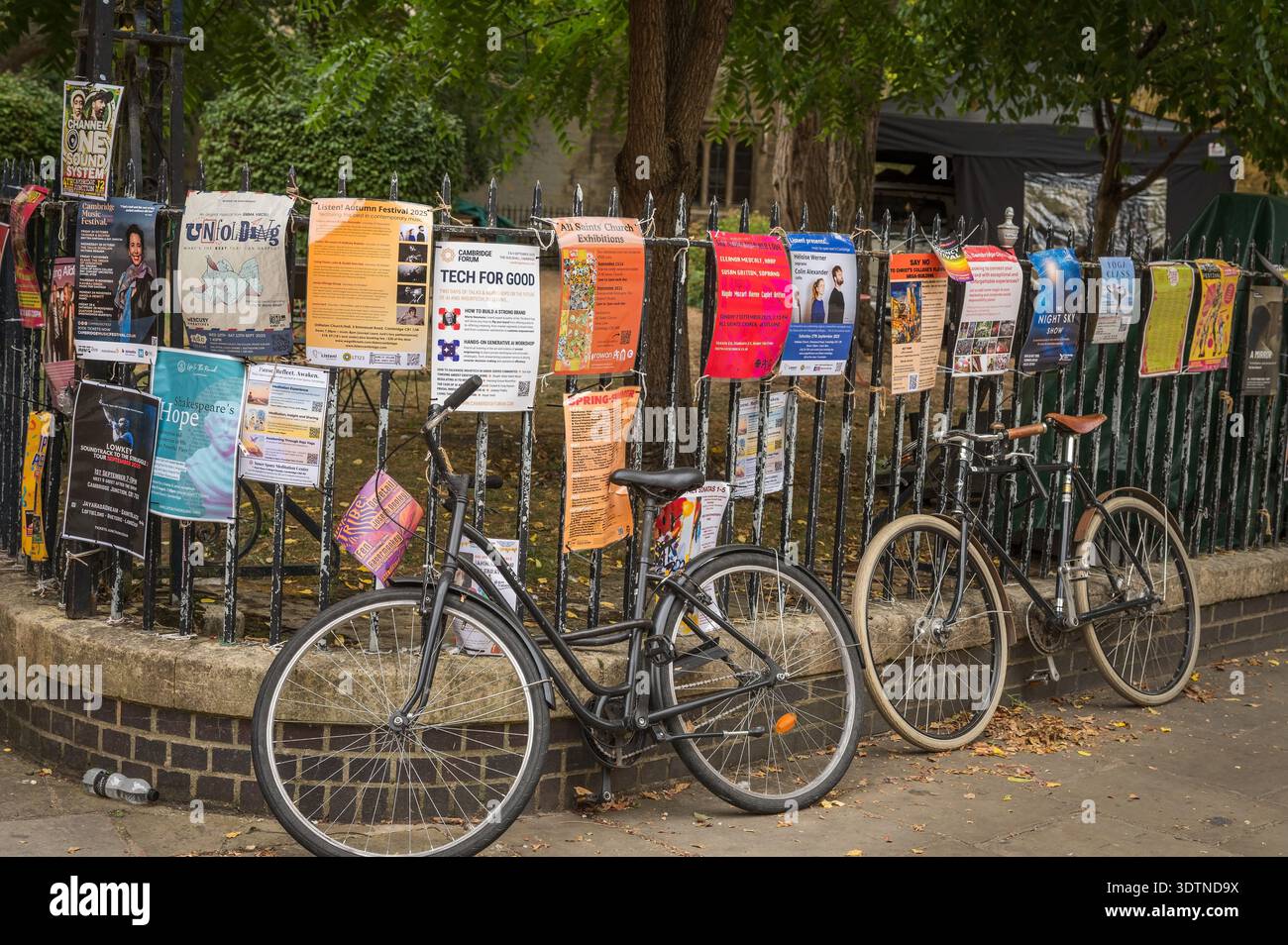 Bicycles chained to fence  along Trinity Street.  Cambridge University, UK. Stock Photo