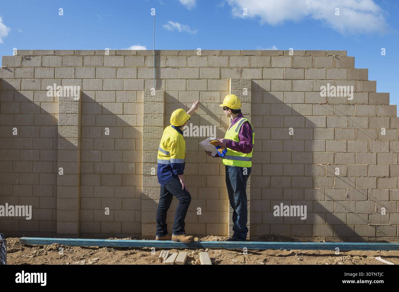 Civil engineer and worker discussing issues at the construction site Stock Photo