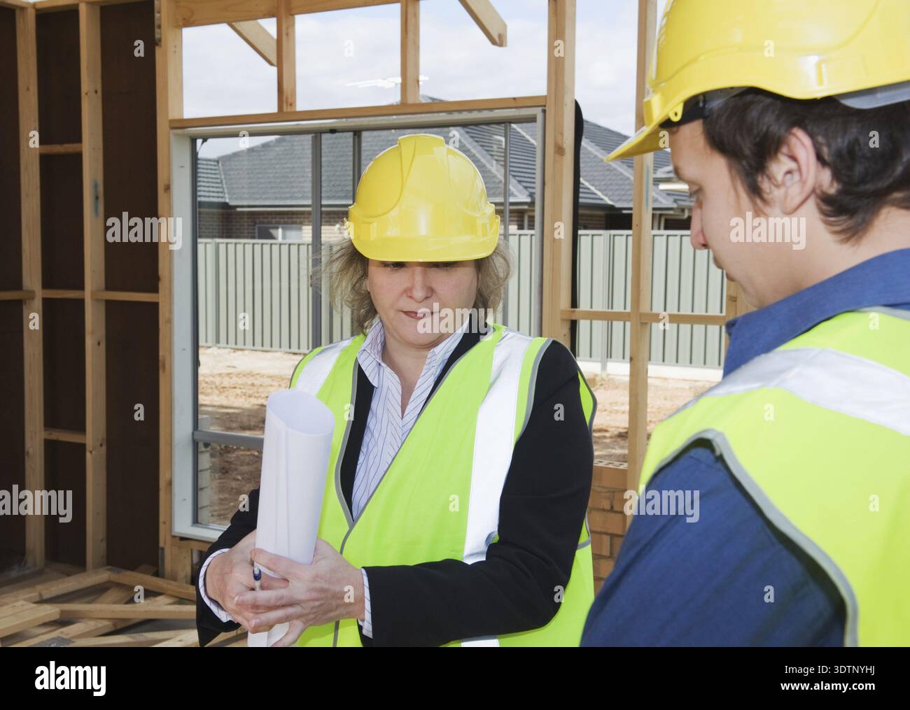 Civil engineer and worker discussing issues at the construction site Stock Photo
