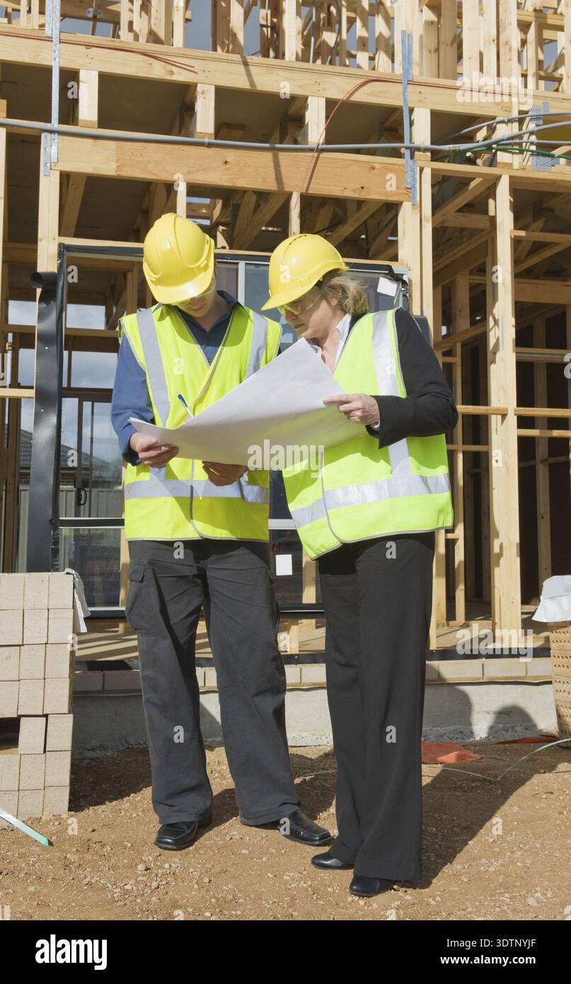 Civil engineer and worker discussing issues at the construction site Stock Photo
