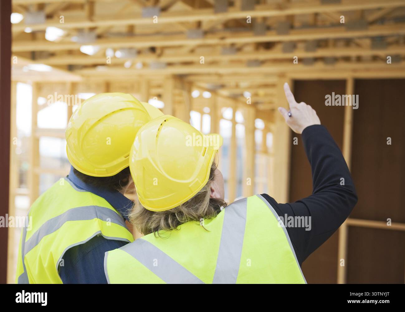 Civil engineer and worker discussing issues at the construction site Stock Photo