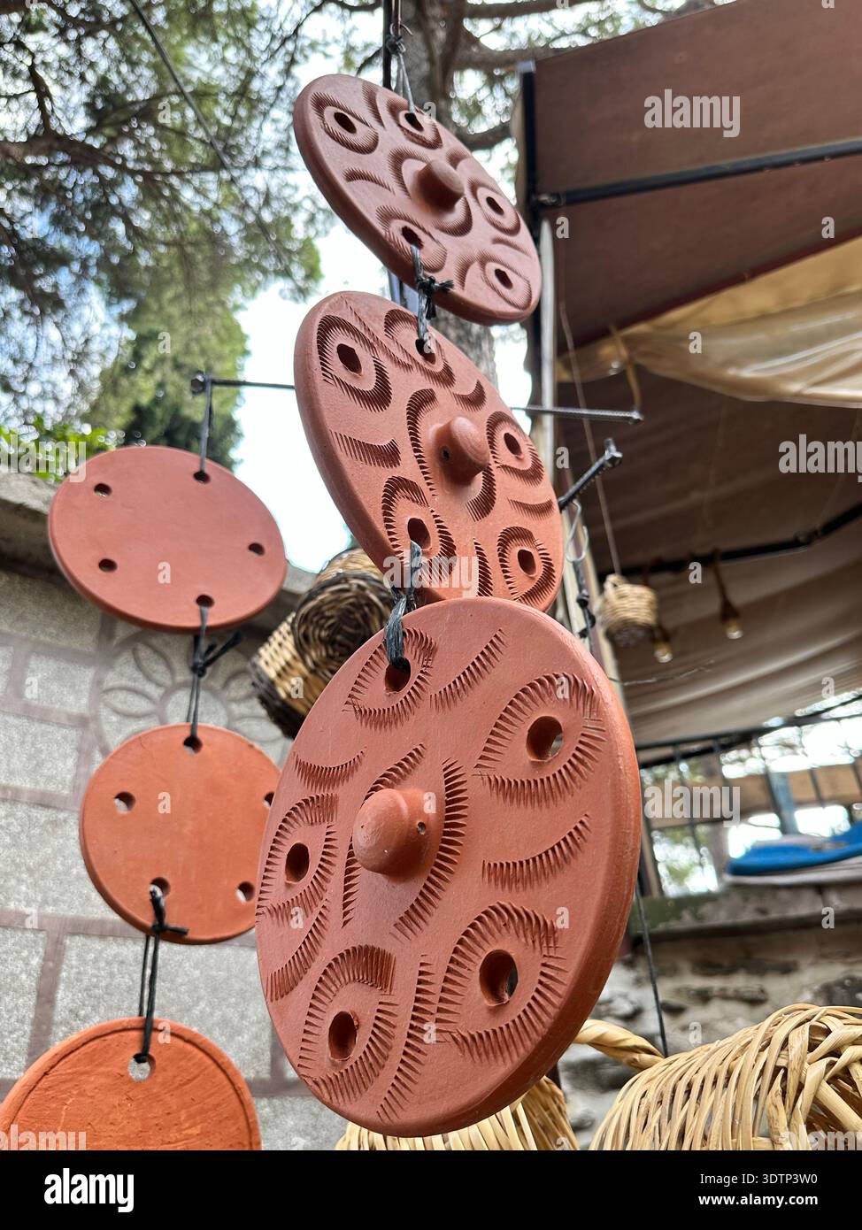 Handmade earthenware lids hanging on a string Stock Photo