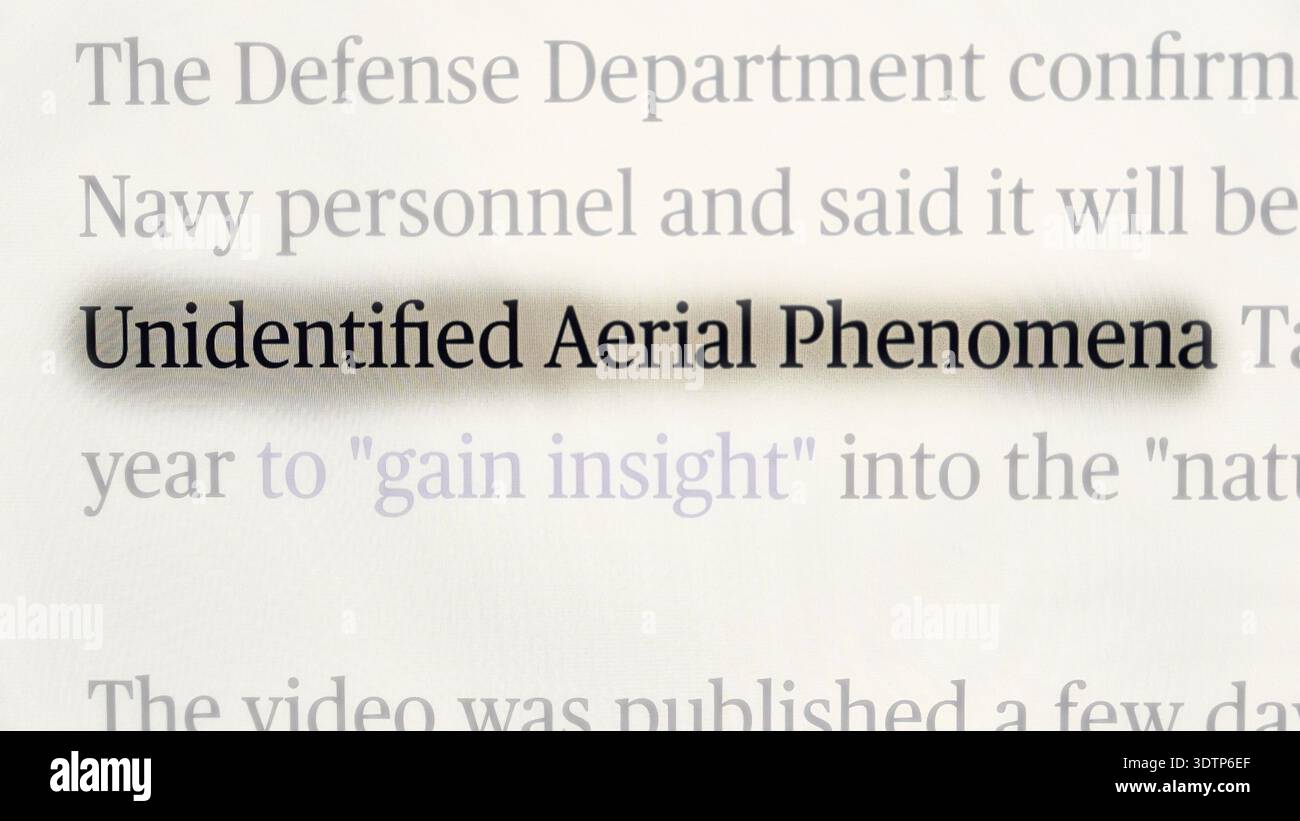 Close-up of a news headline highlighting the term “Unidentified Aerial Phenomena,” referencing official statements from the U.S. Defense Department Stock Photo