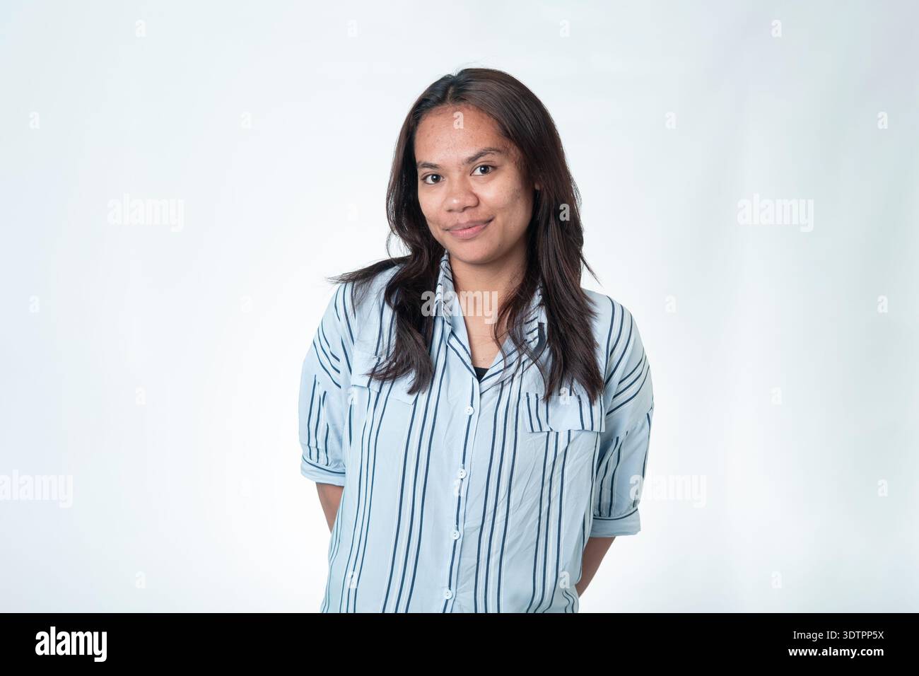 Standing woman in blue shirt hi-res stock photography and images - Alamy