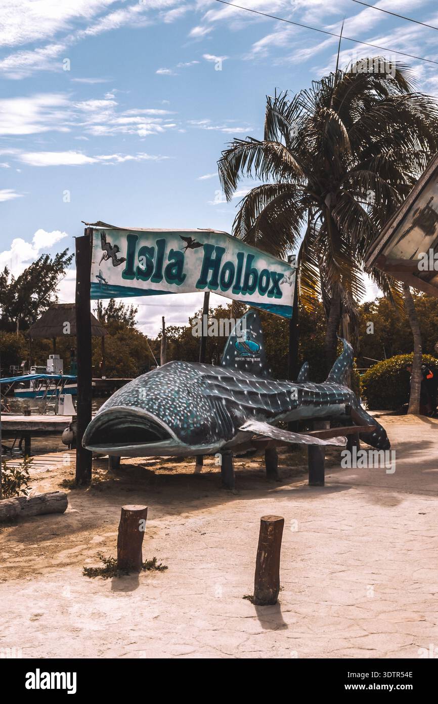 Isla Sign Isla Holbox entrance sign with whale shark sculpture and palm trees in ...
