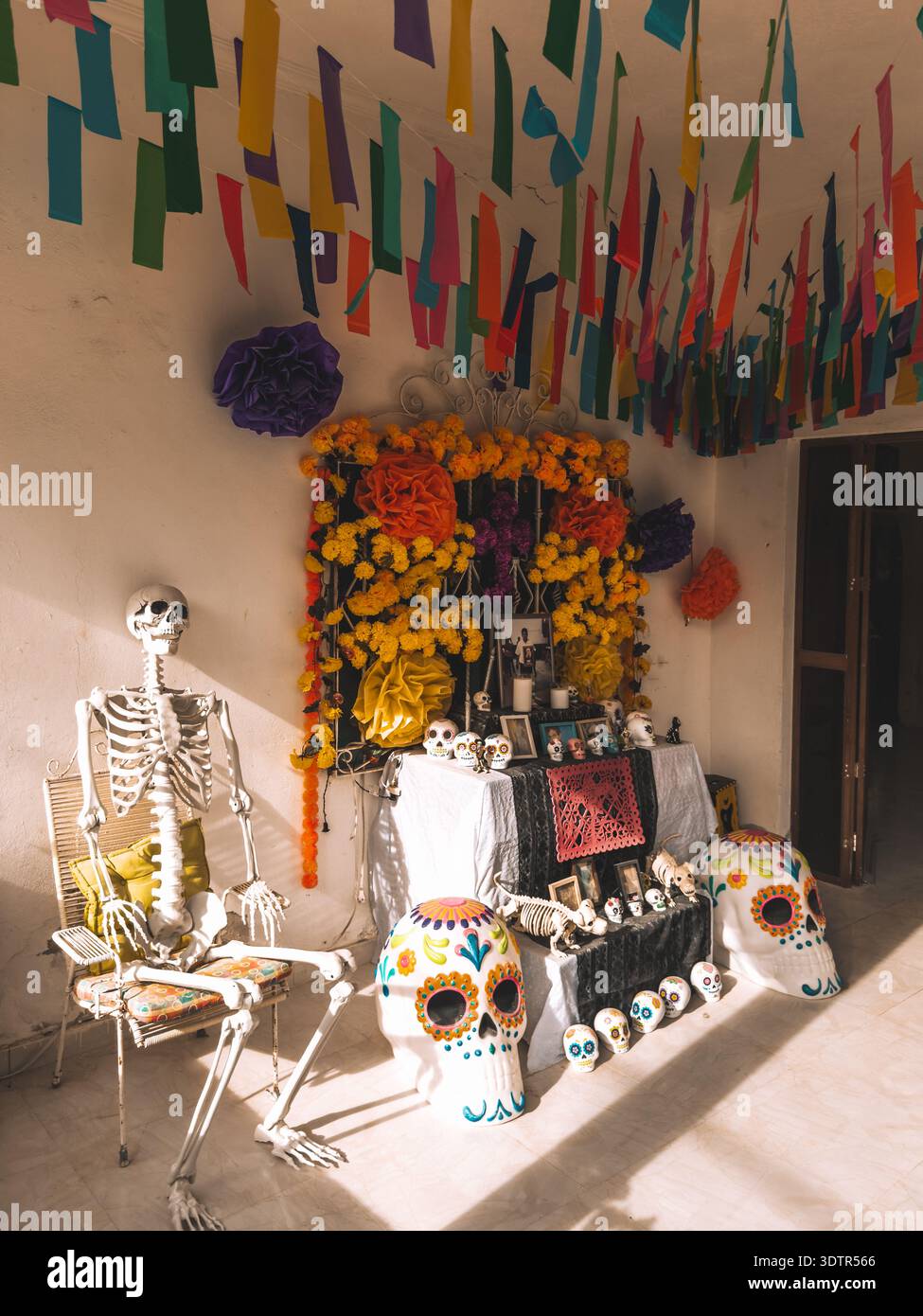 Traditional Day of the Dead altar with marigolds, sugar skulls and skeleton decorations in Holbox, Mexico. Stock Photo
