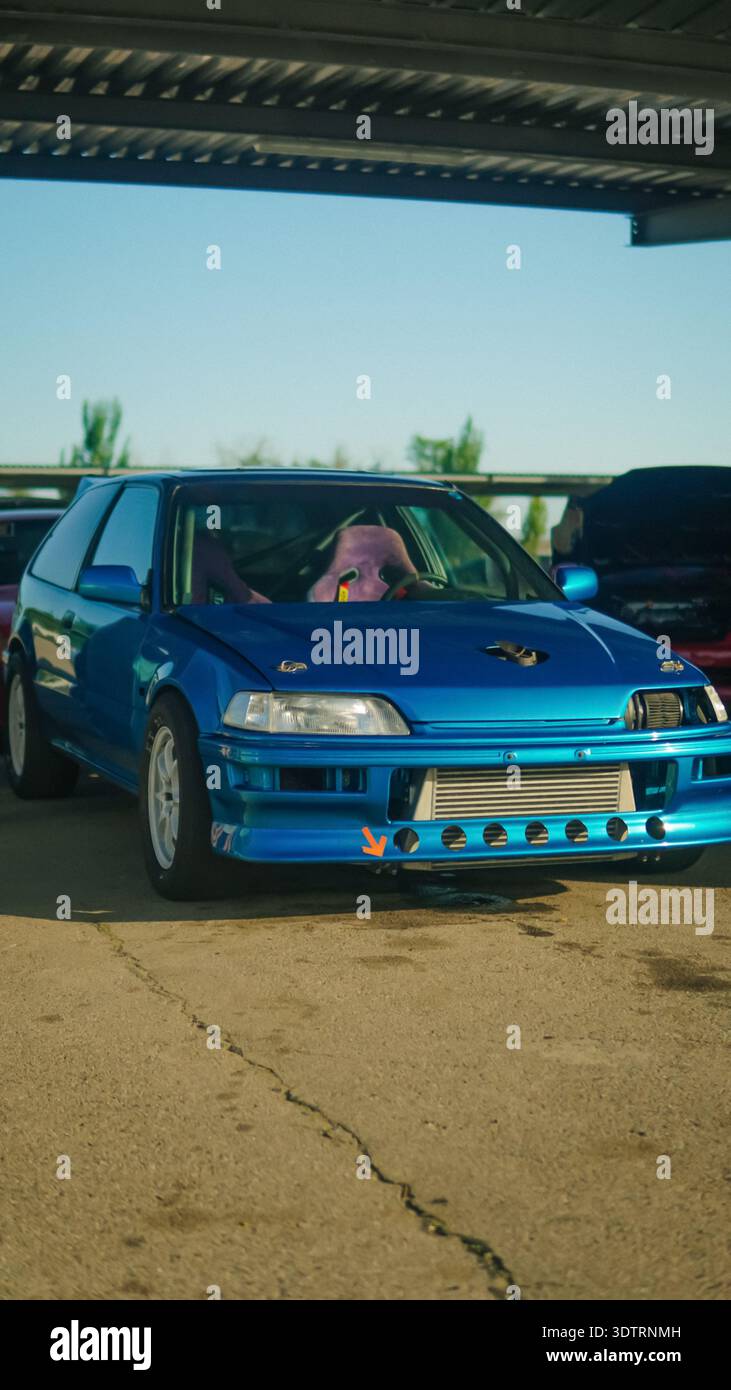 A Stunning Blue Modified Car Showcasing Custom Features Underneath a ...