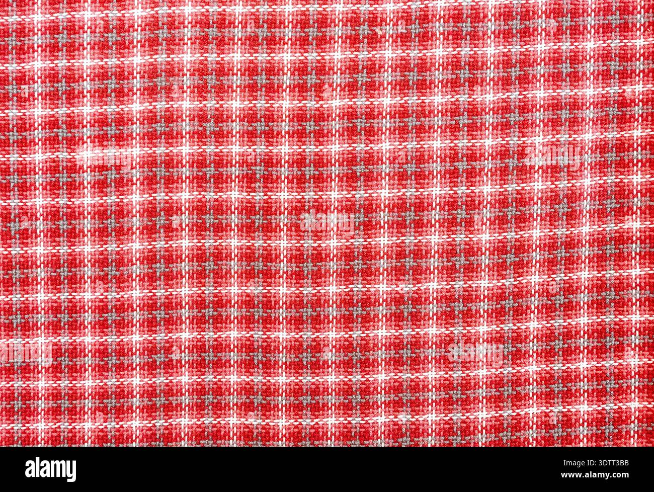 Woven wool fabric as a creative backdrop. Wool fabric texture. Threads texture as background in red Stock Photo