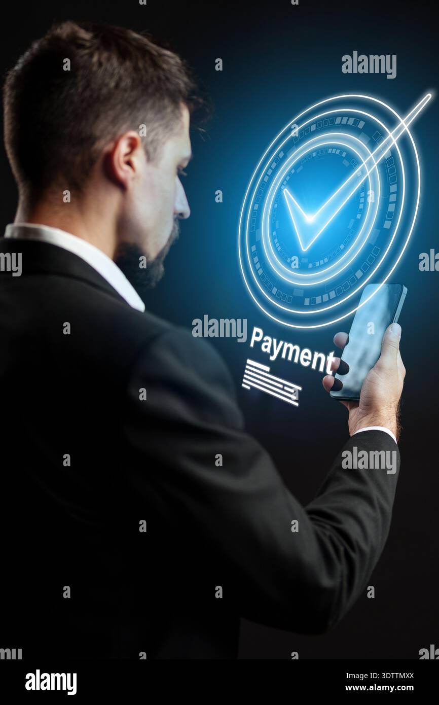 Man makes banking invoice payment using smartphone in modern setting Stock Photo