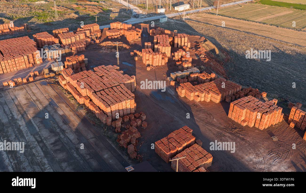 Aerial view of the brick factory storage area. Thousands of stacked red ...