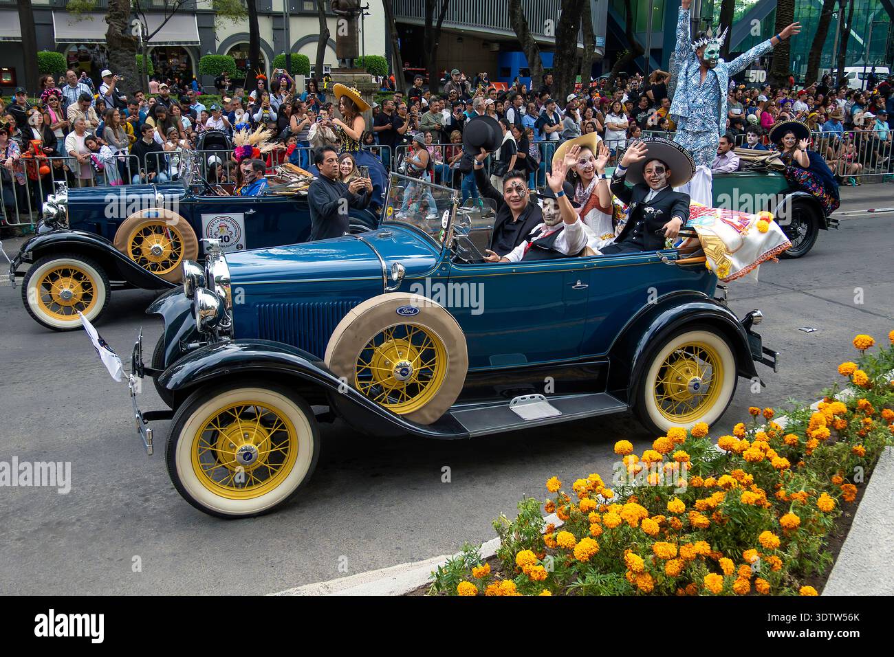 People in vintage cars and on stilts parade on the Day of the Dead in Mexico City, Mexico Stock Photo