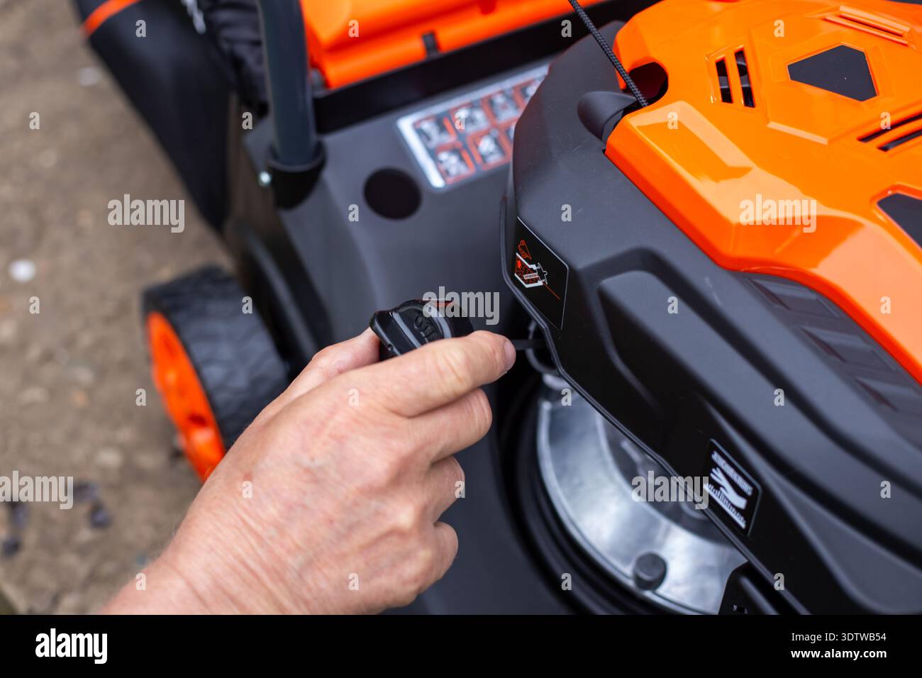 Small Engine Pull Rope Handle Hand pulling the starter rope of a lawnmower engine. starting mower ...