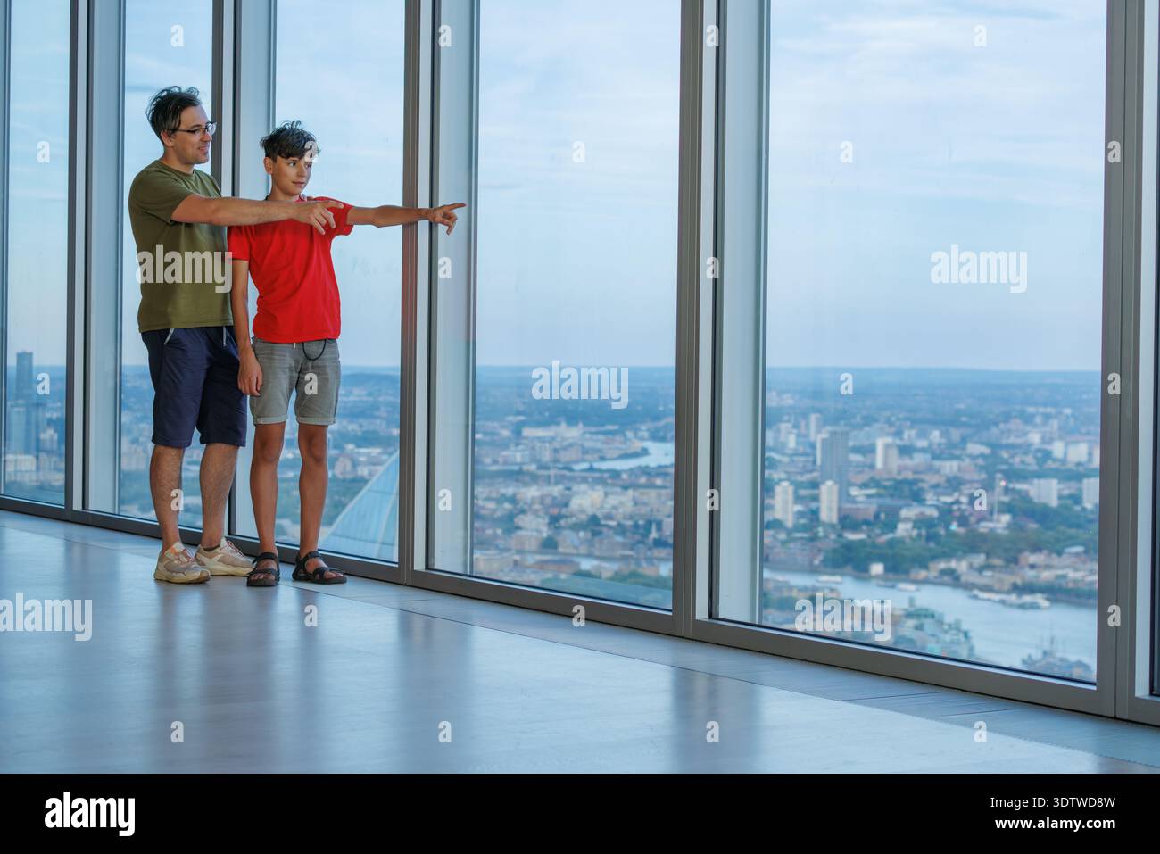 There Point Out A father and son visiting London point out famous landmarks from a tall ...