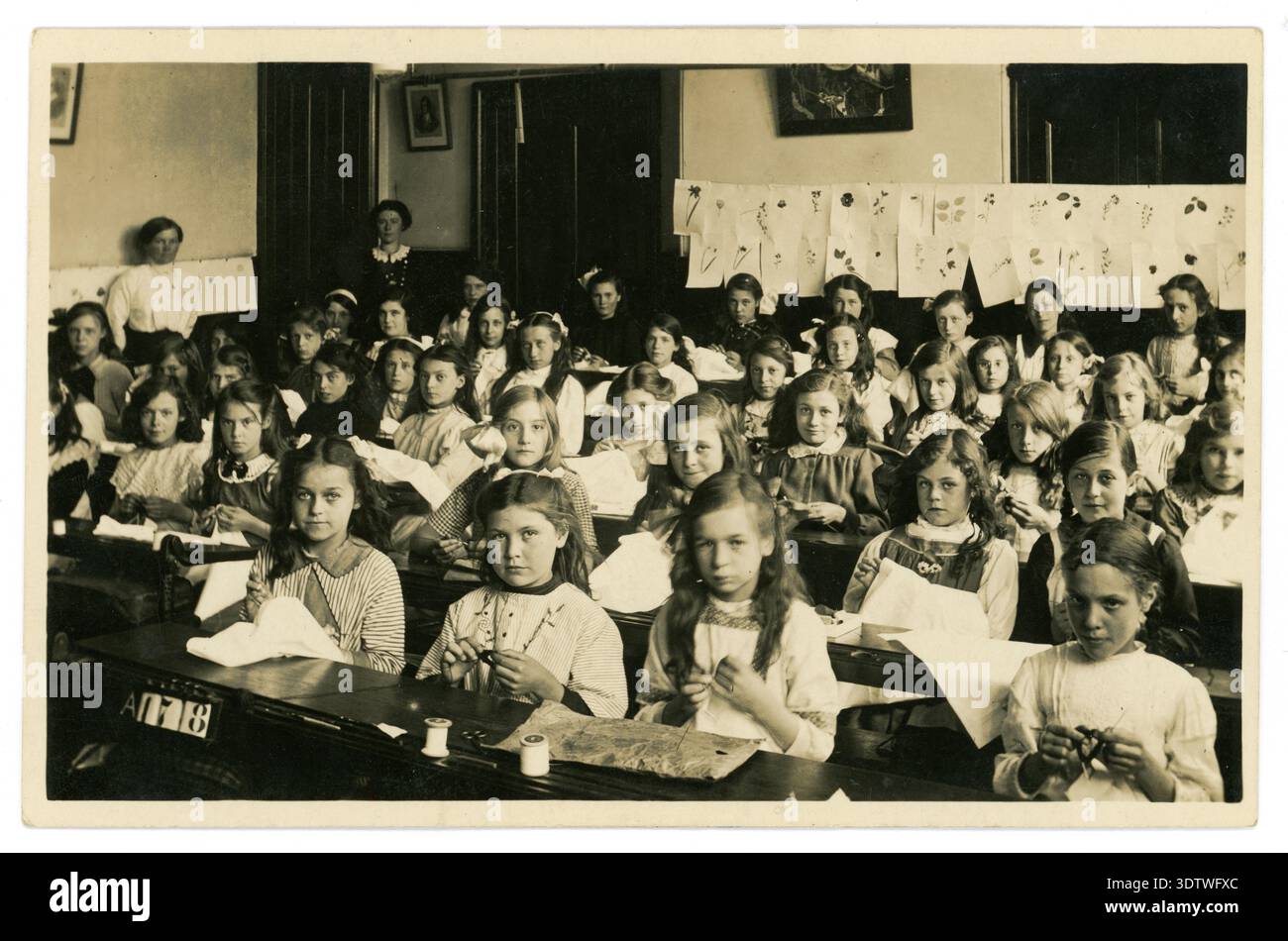1900s WW1 era school children in classroom, girls sewing class, classes, Victorian 1900's schoolgirls. By J&G Taylor, London, UK  Circa 1913-1919. Stock Photo