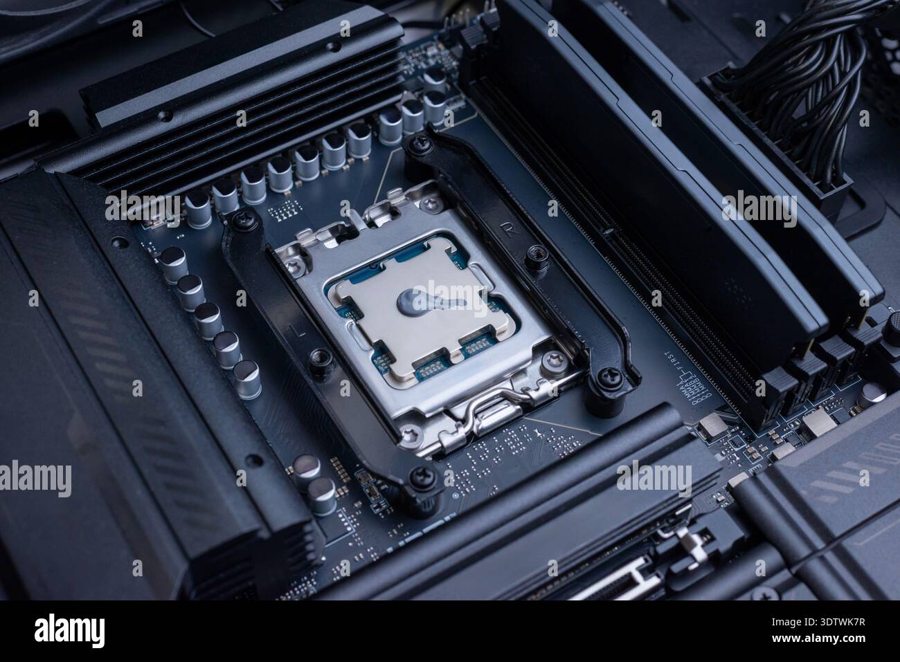 Desktop processor with applied thermal paste installed on motherboard socket, computer cooling preparation and high performance pc build concept Stock Photo