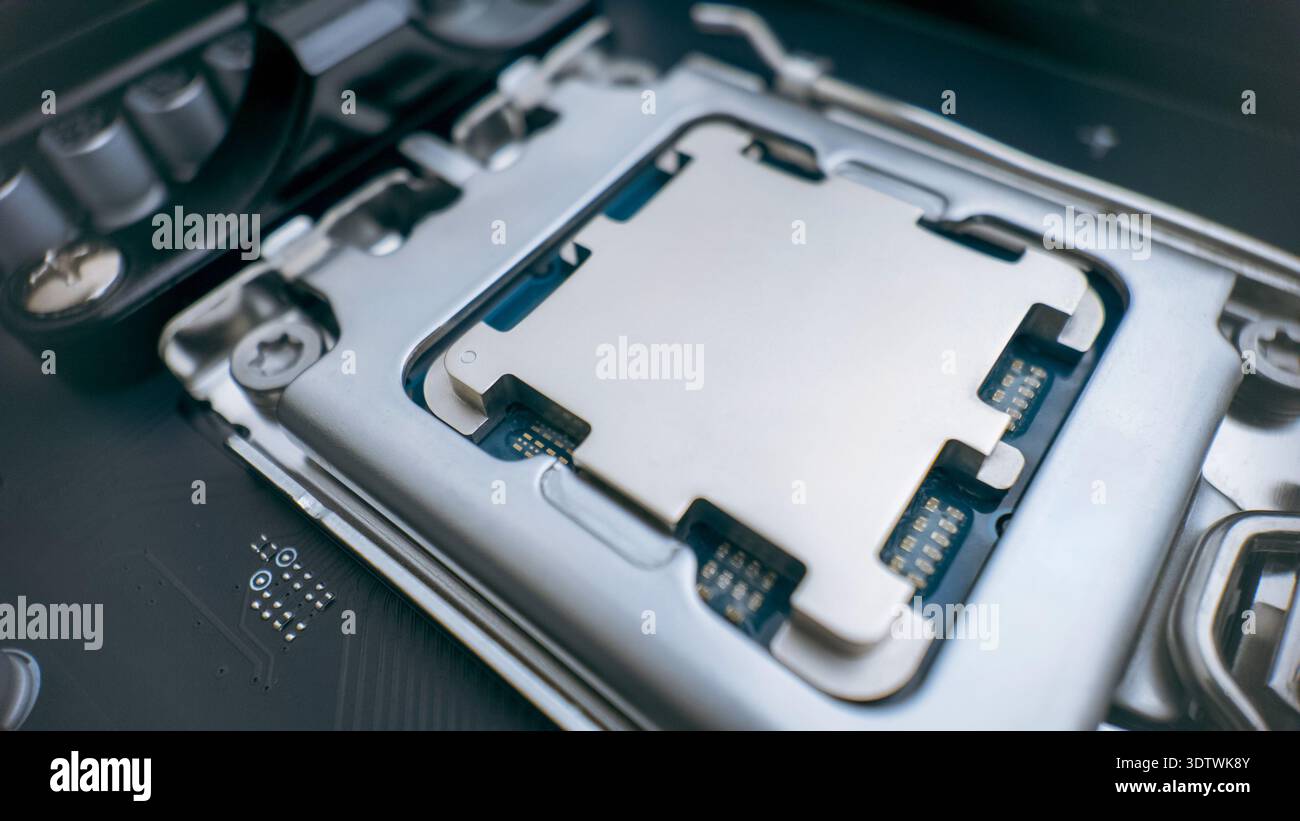 Modern desktop processor installed in motherboard socket, close up of cpu contact plate and high performance computer hardware technology concept Stock Photo
