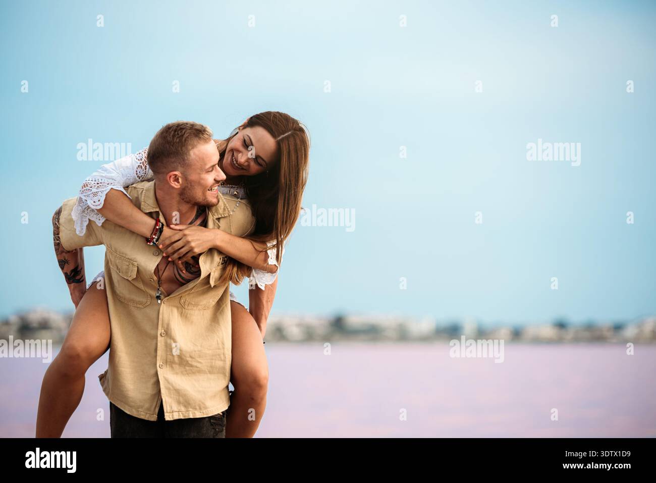 An adorable couple enjoying a playful piggyback ride by the stunning ...
