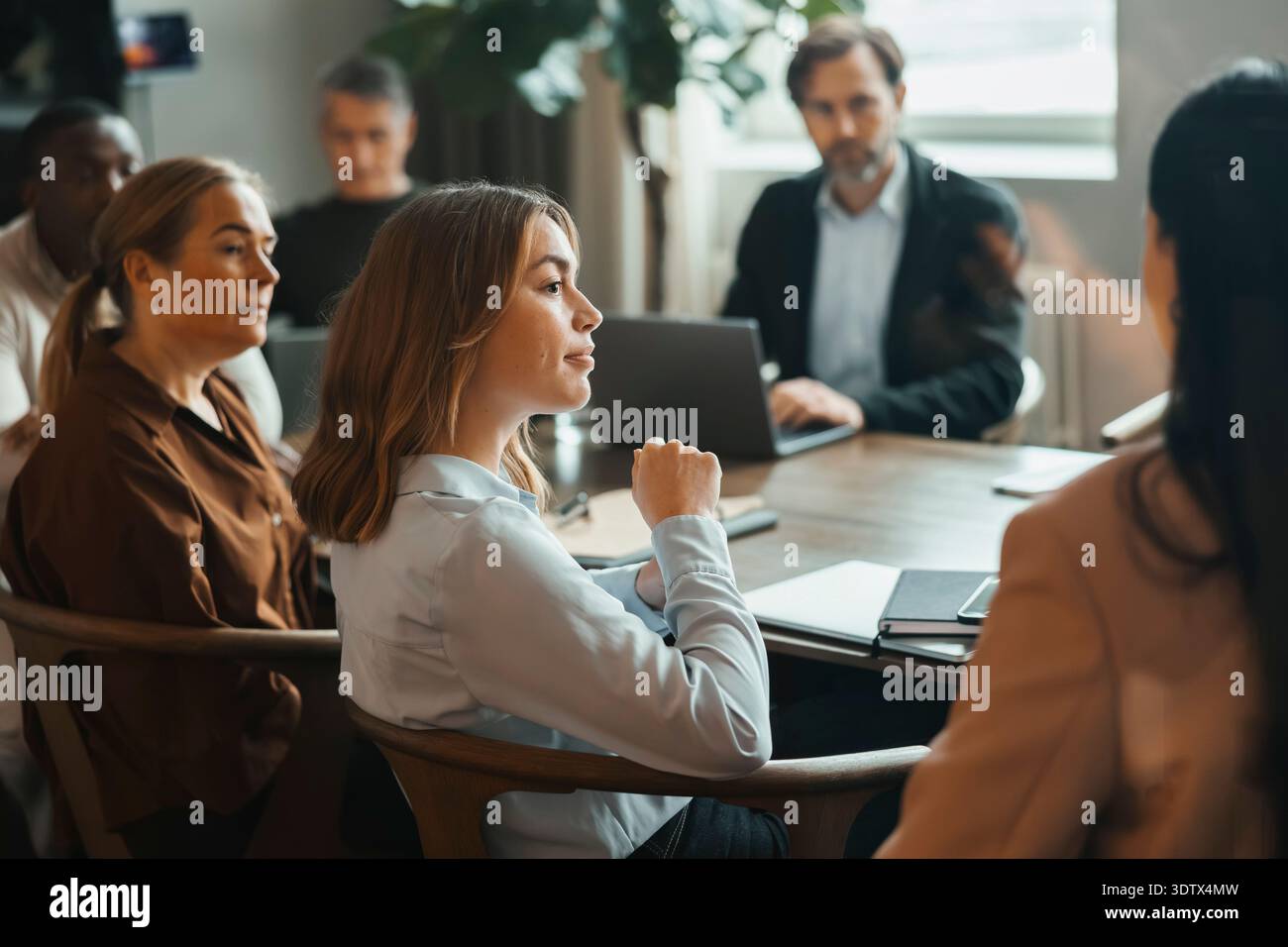 Team of corporate professionals attending group meeting at office Stock Photo