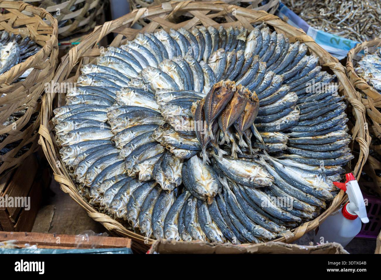 Circular arrangement of dried fish in a woven basket at Taboan Public ...