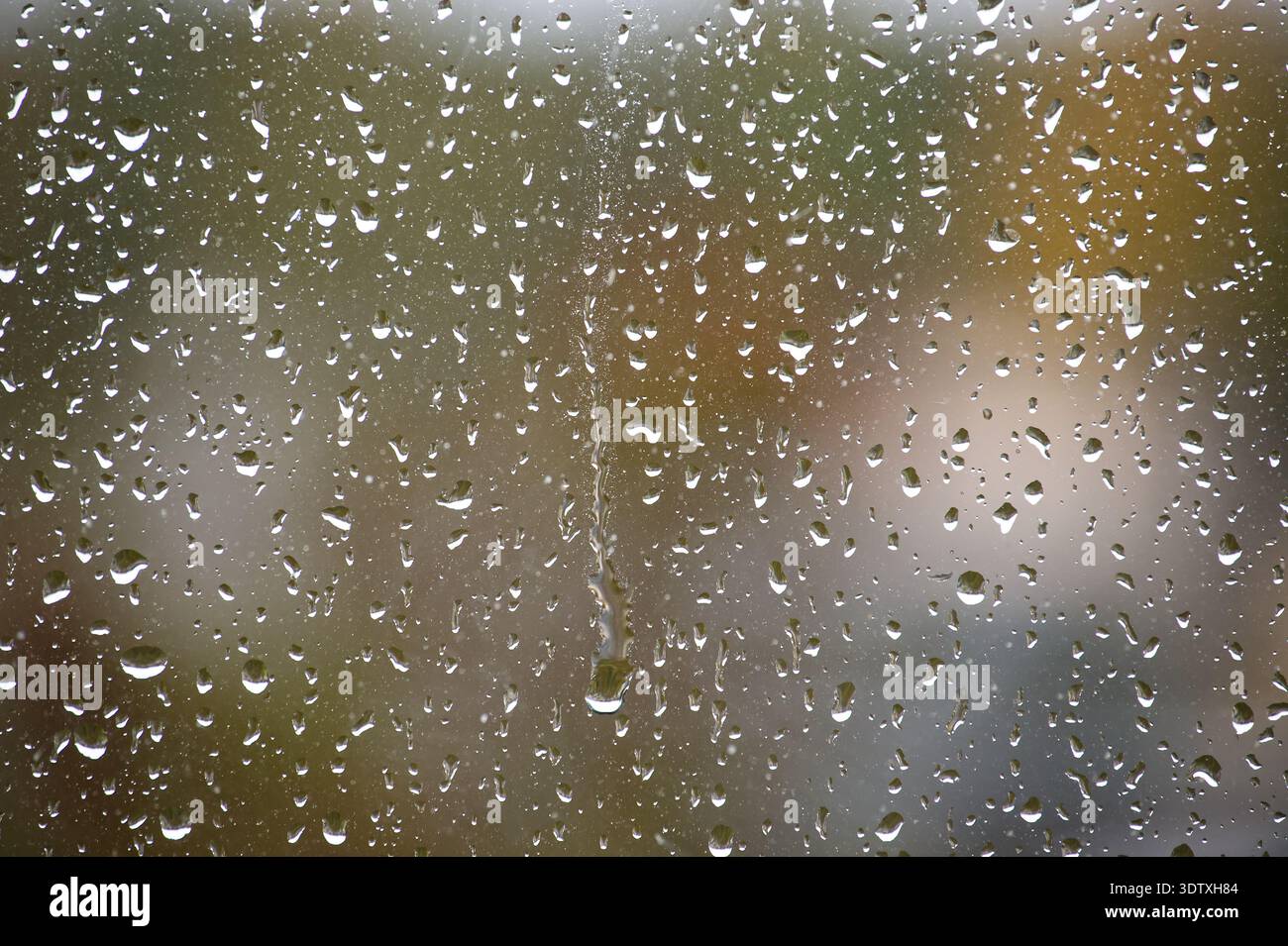 The raindrops create a mesmerizing pattern, offering a unique perspective on the world outside Stock Photo