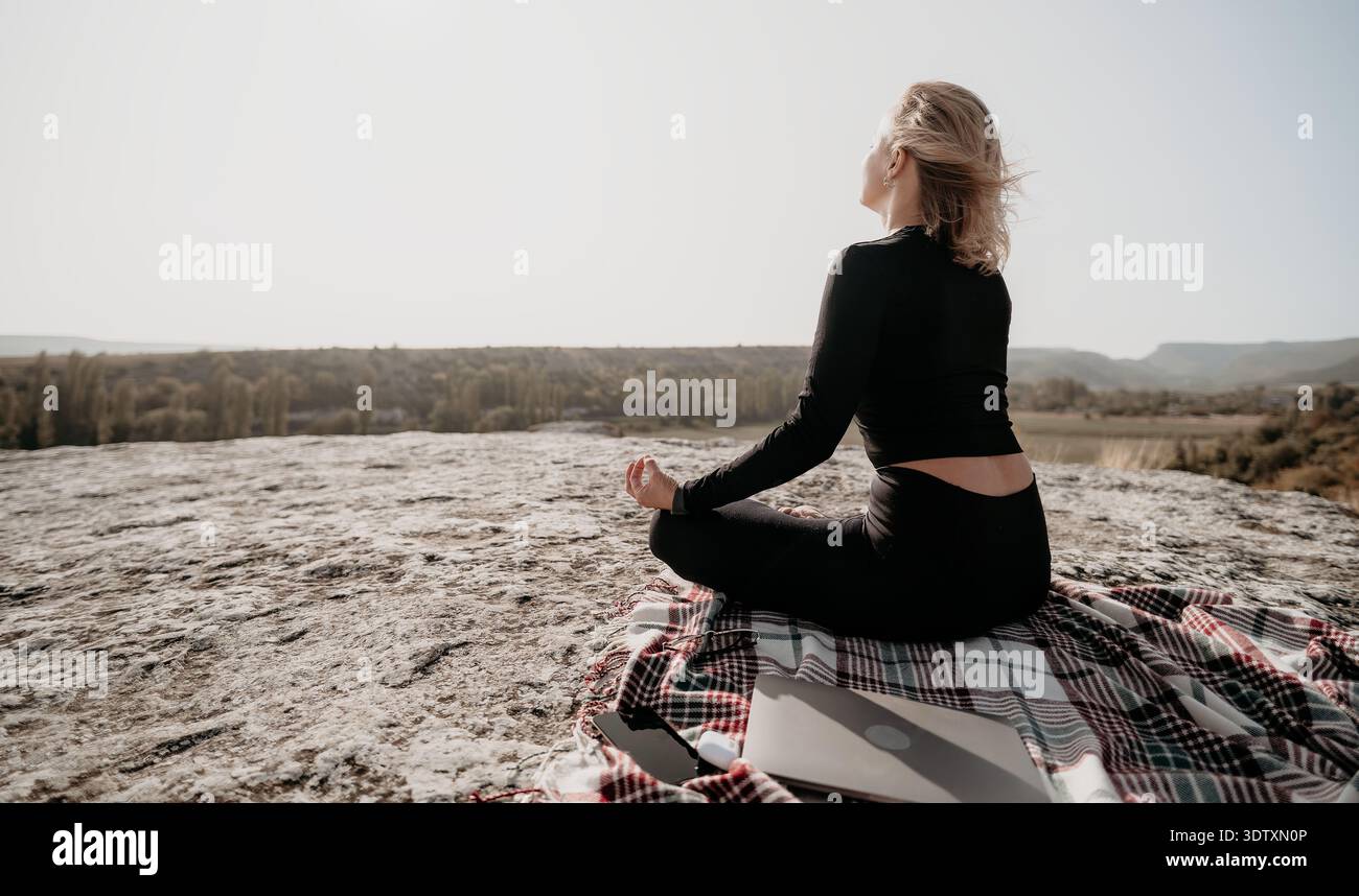 Woman Meditating on a Mountaintop Stock Photo