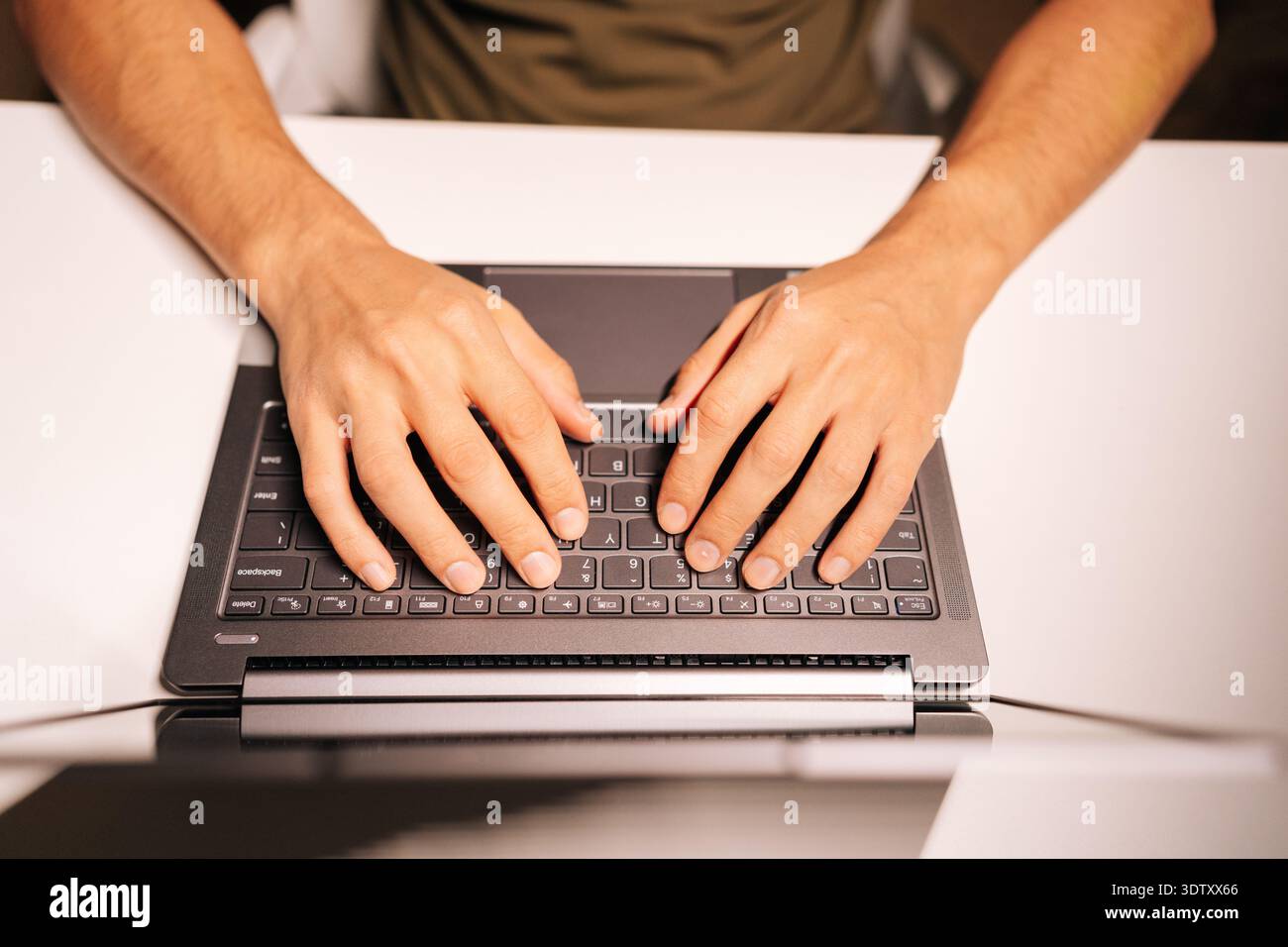 Top view of programmer hands typing on laptop keyboard, coding software, developing technology, working remotely, searching information, focusing on Stock Photo