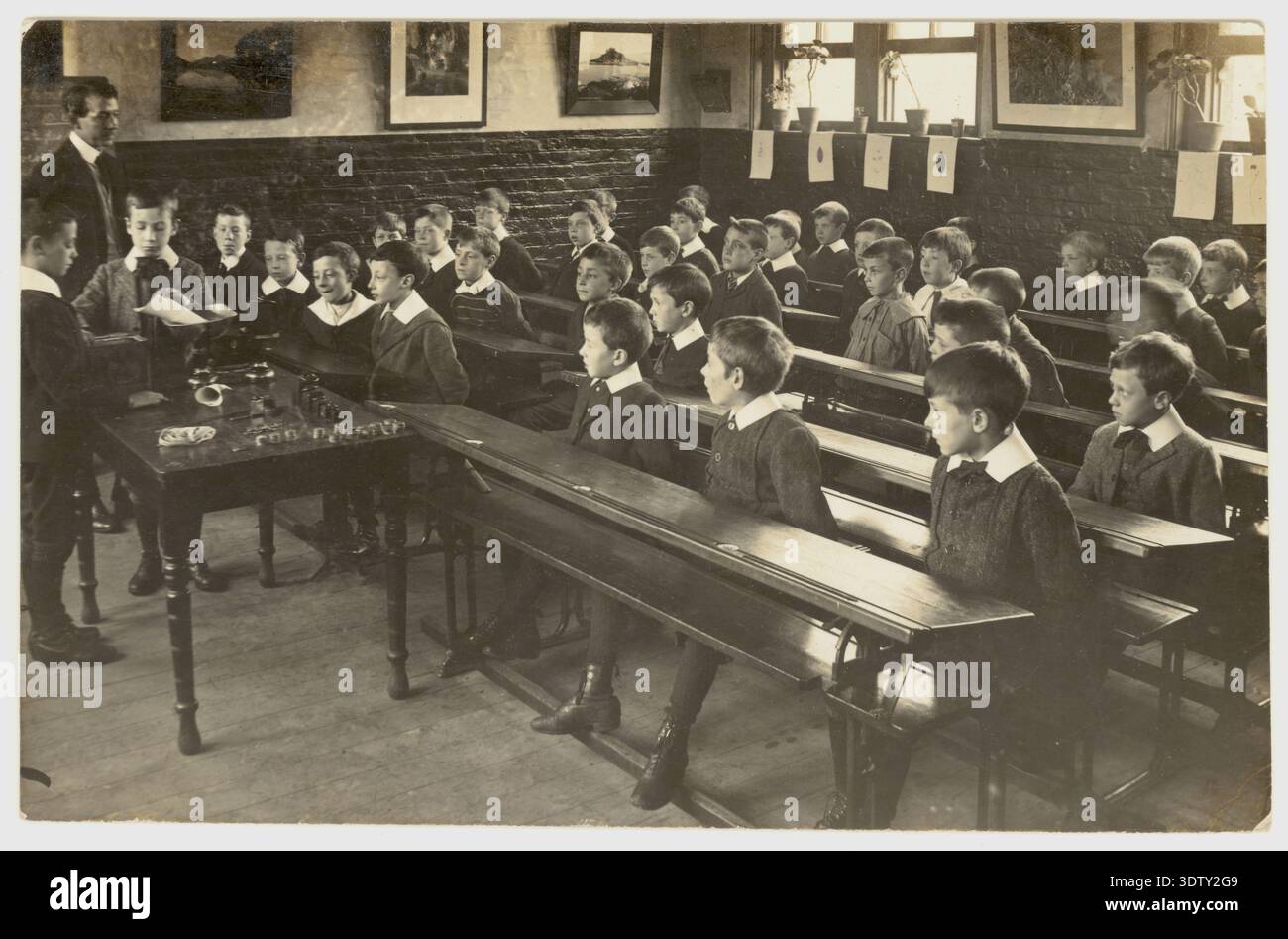 Edwardian junior school boys & teacher in classroom learning about ...