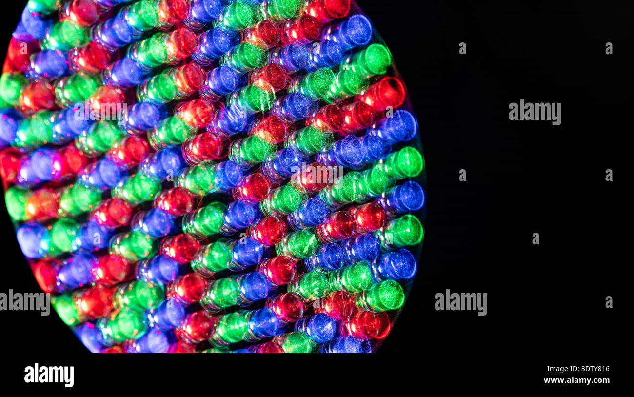 Close up detail of red green and blue LED diodes on a professional lighting fixture for concert stages and large digital screens against a black backg Stock Photo