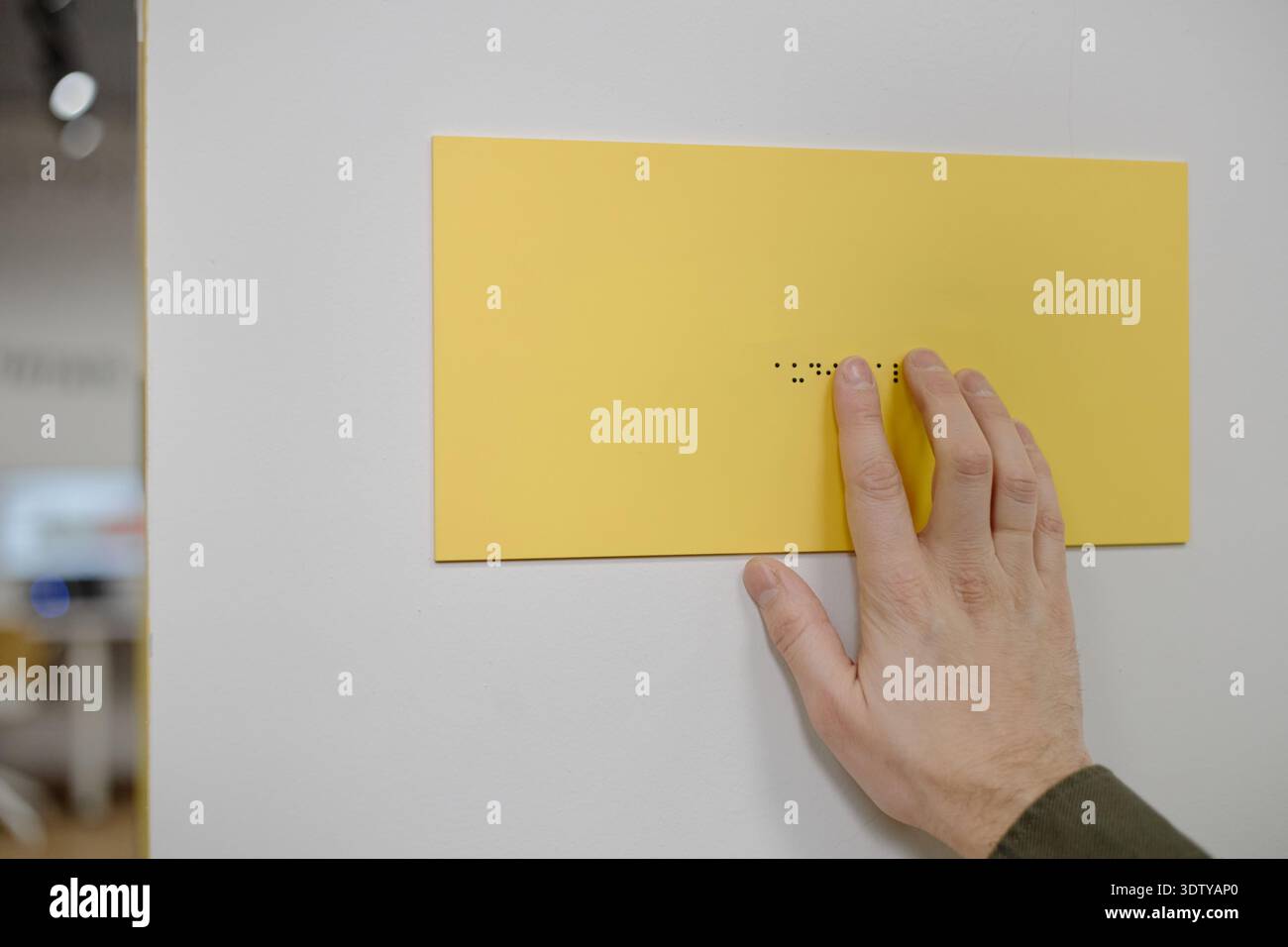 Man Reading Braille Signage Inside Library Setting Stock Photo