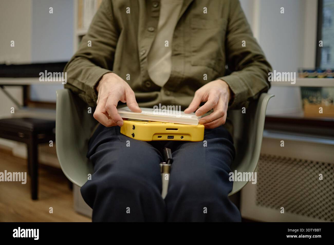 Middle Aged Man Using Assistive Device in Library Stock Photo
