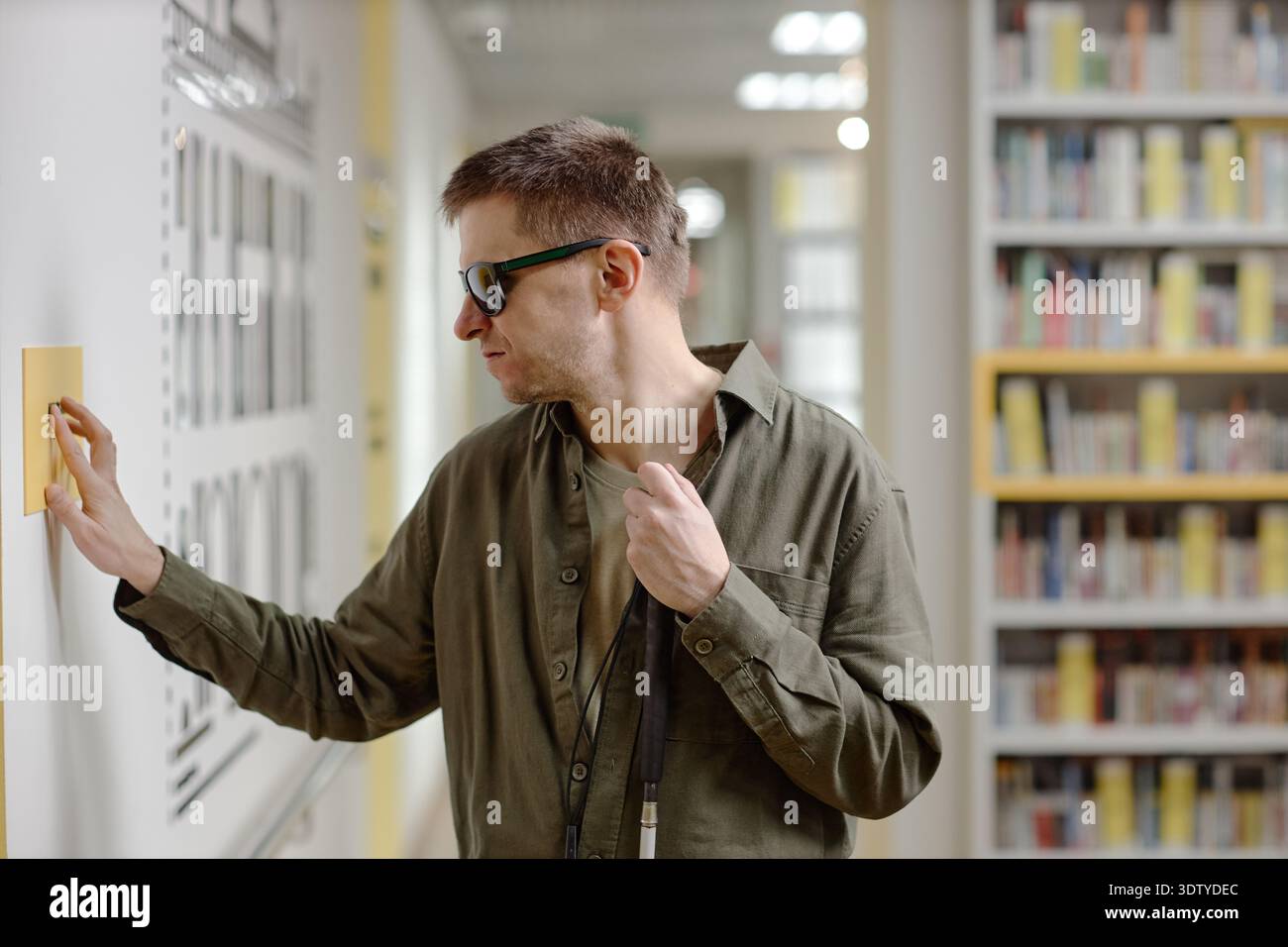 Middle Aged Man Using Tactile Signage Navigating Library Independently Stock Photo