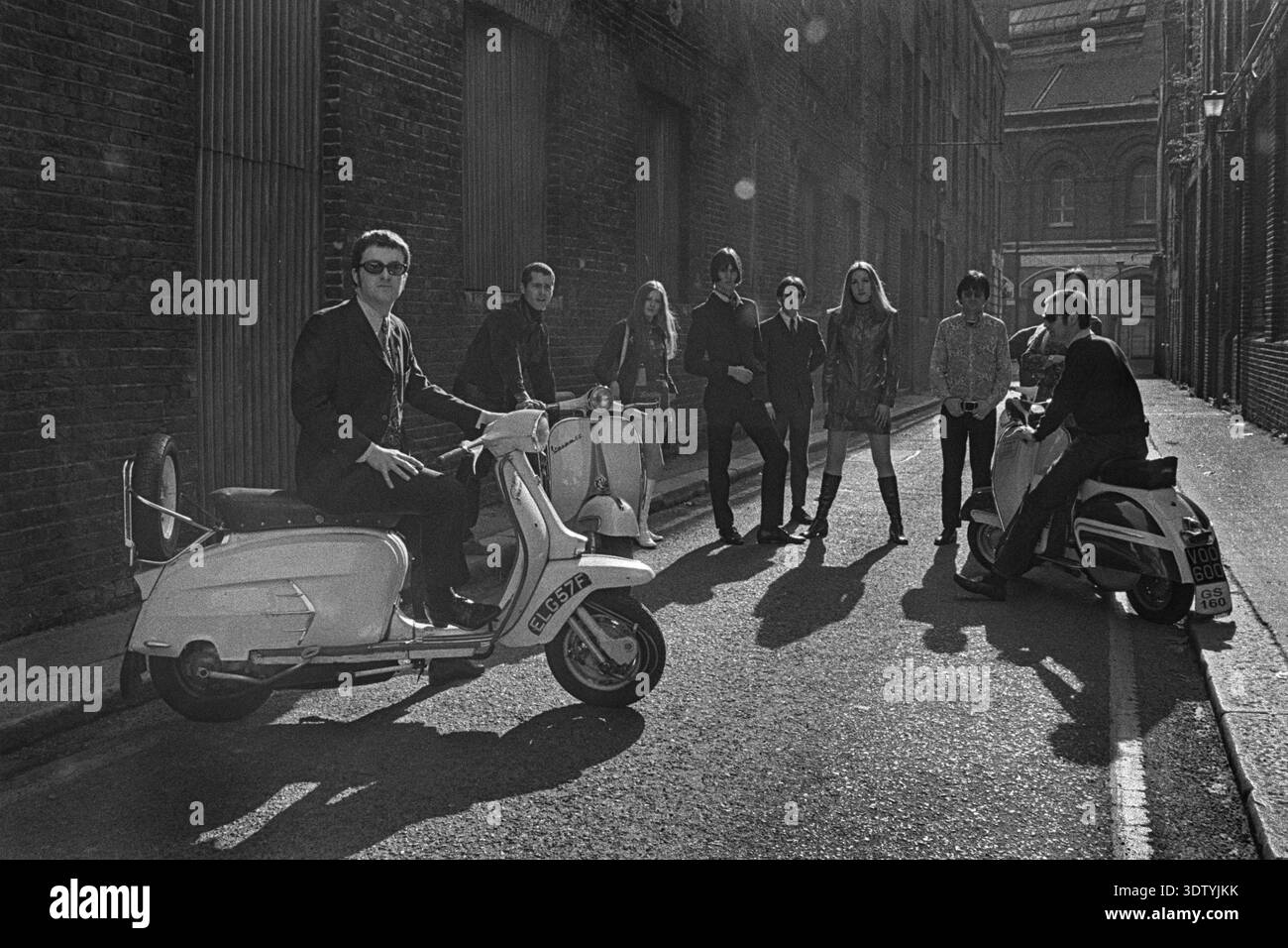 Group of stylish Mod posing with a scooter in London’s King’s Cross ...