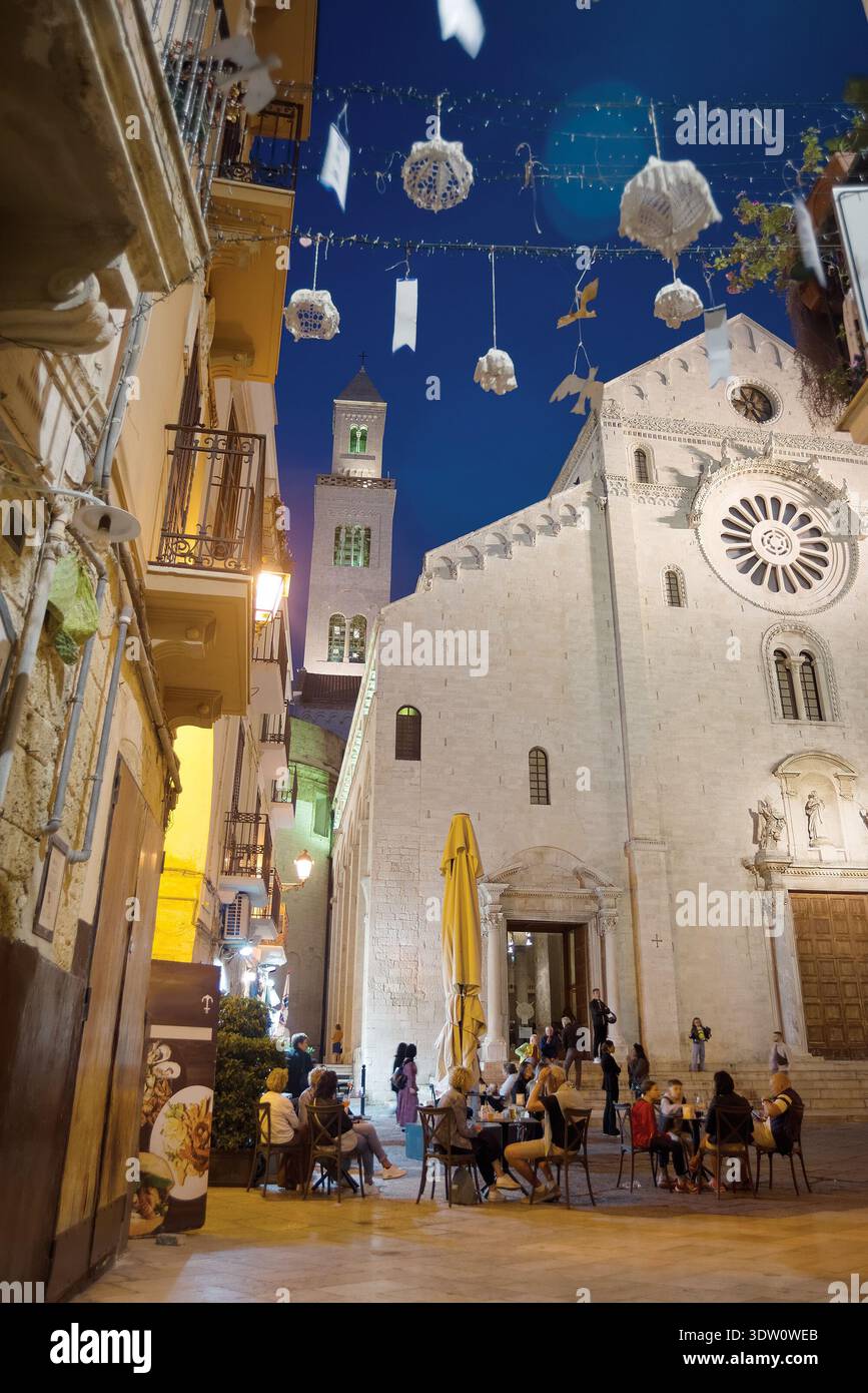 Night view of Bari street featuring people dining outdoors Stock Photo ...