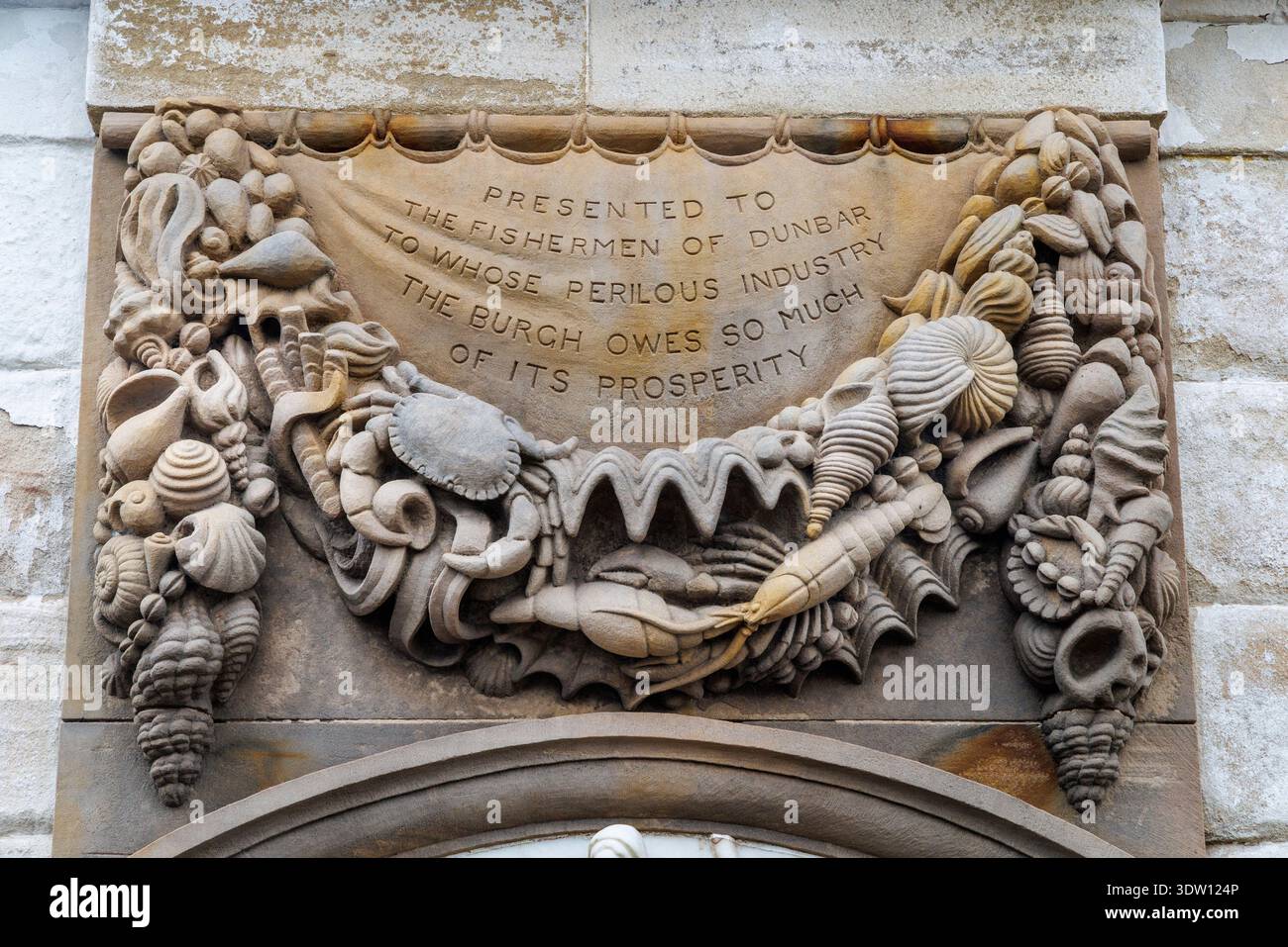 Motif on the Fishermen's Monument with a Barometer for boats installation on the harbout quay, Dunbar, Scotland, UK Stock Photo
