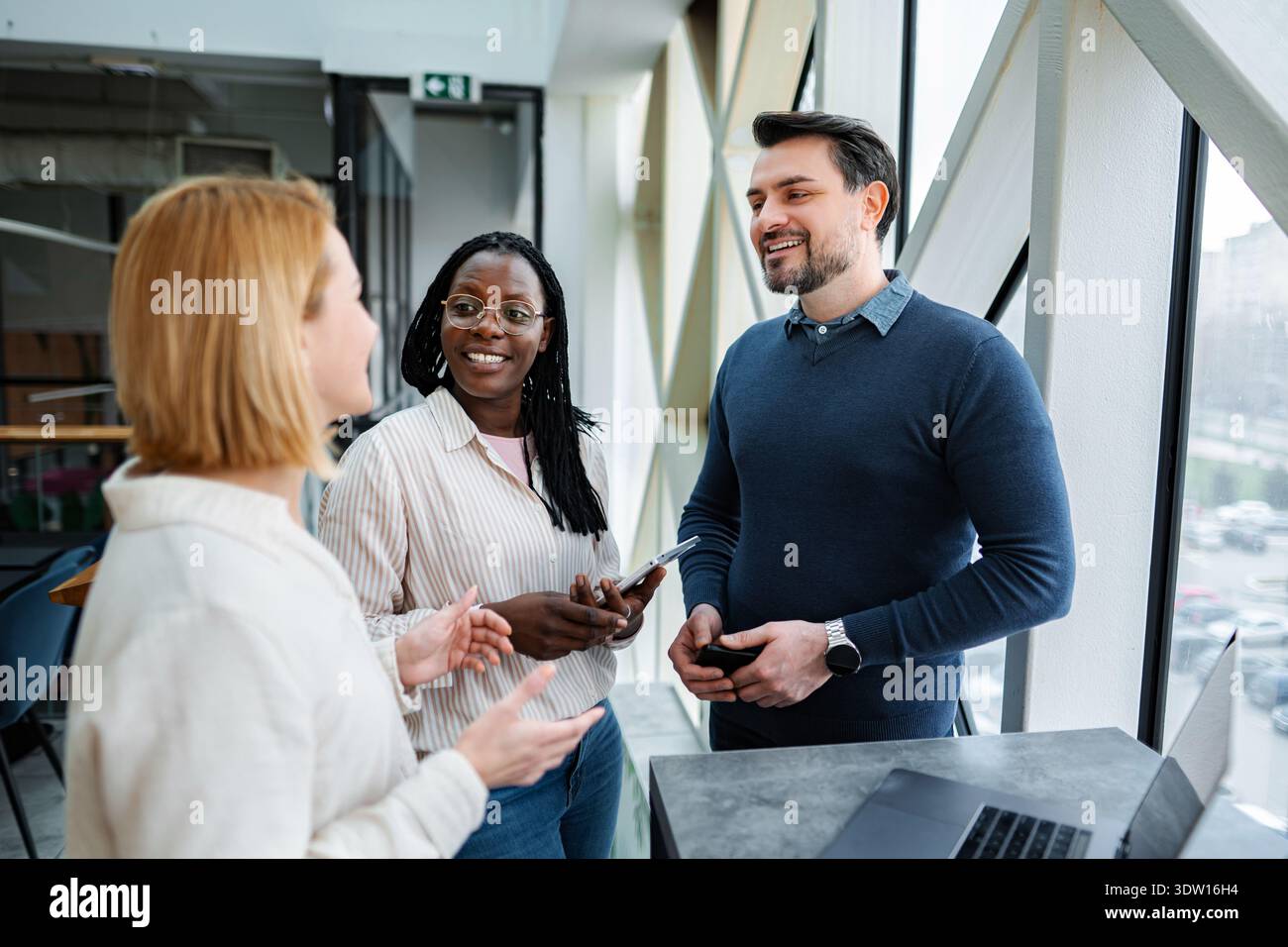 Diverse business people communicating and collaborating in a modern office Stock Photo