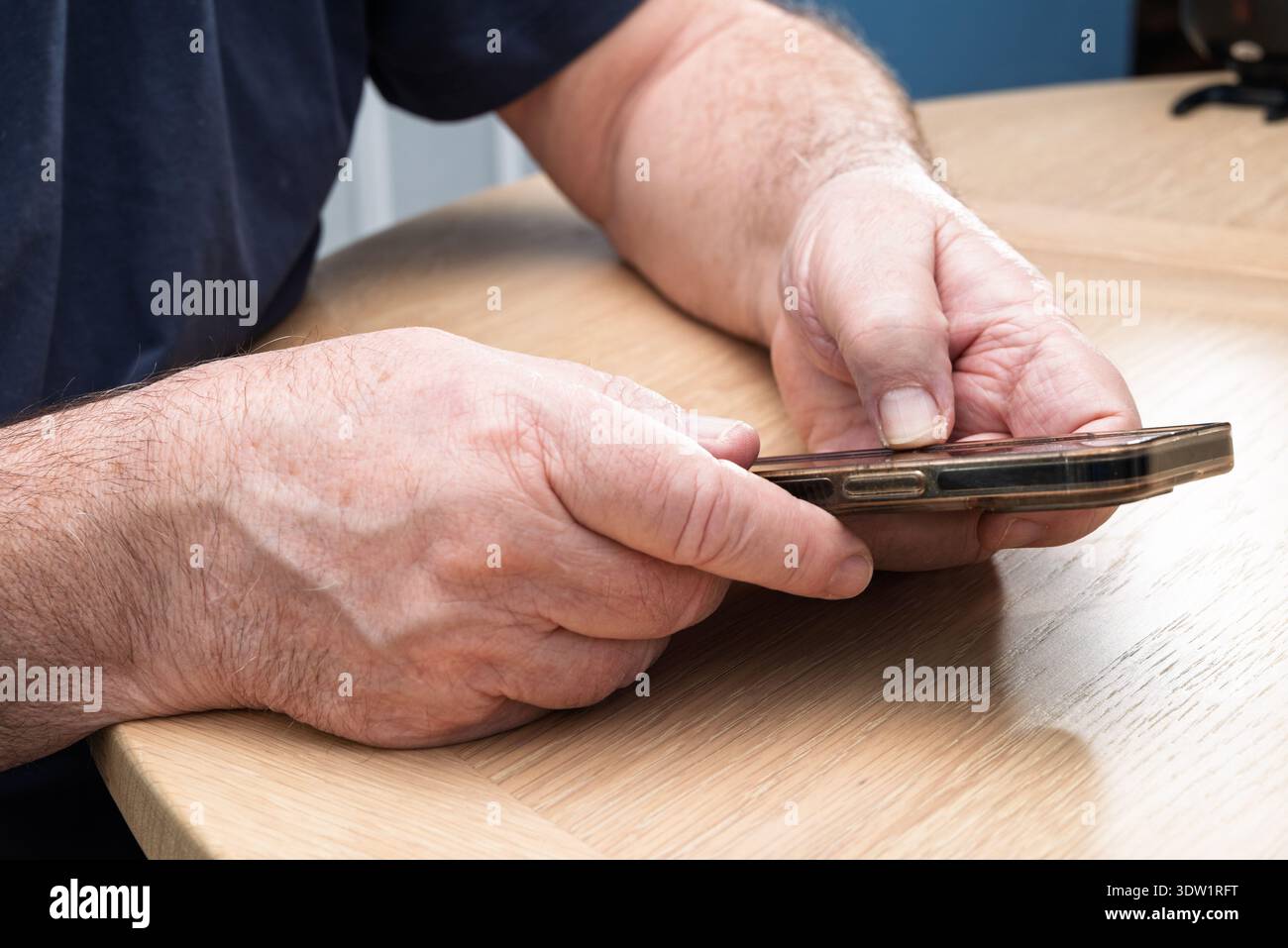 An elderly person using a smart phone and new technology. Stock Photo