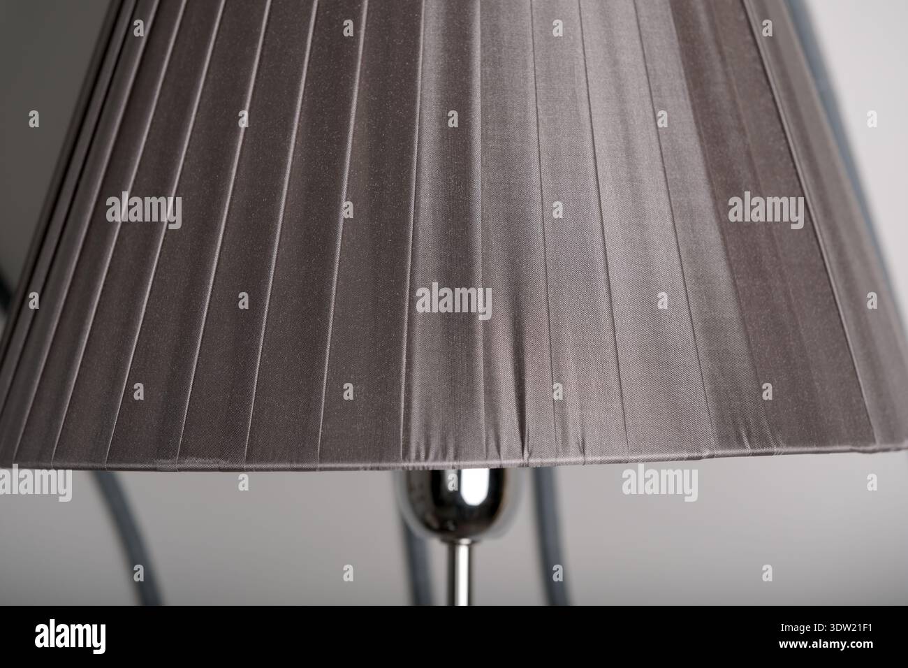 Soft fabric lamp shade brightens a calm space, creating a warm and inviting atmosphere. Stock Photo